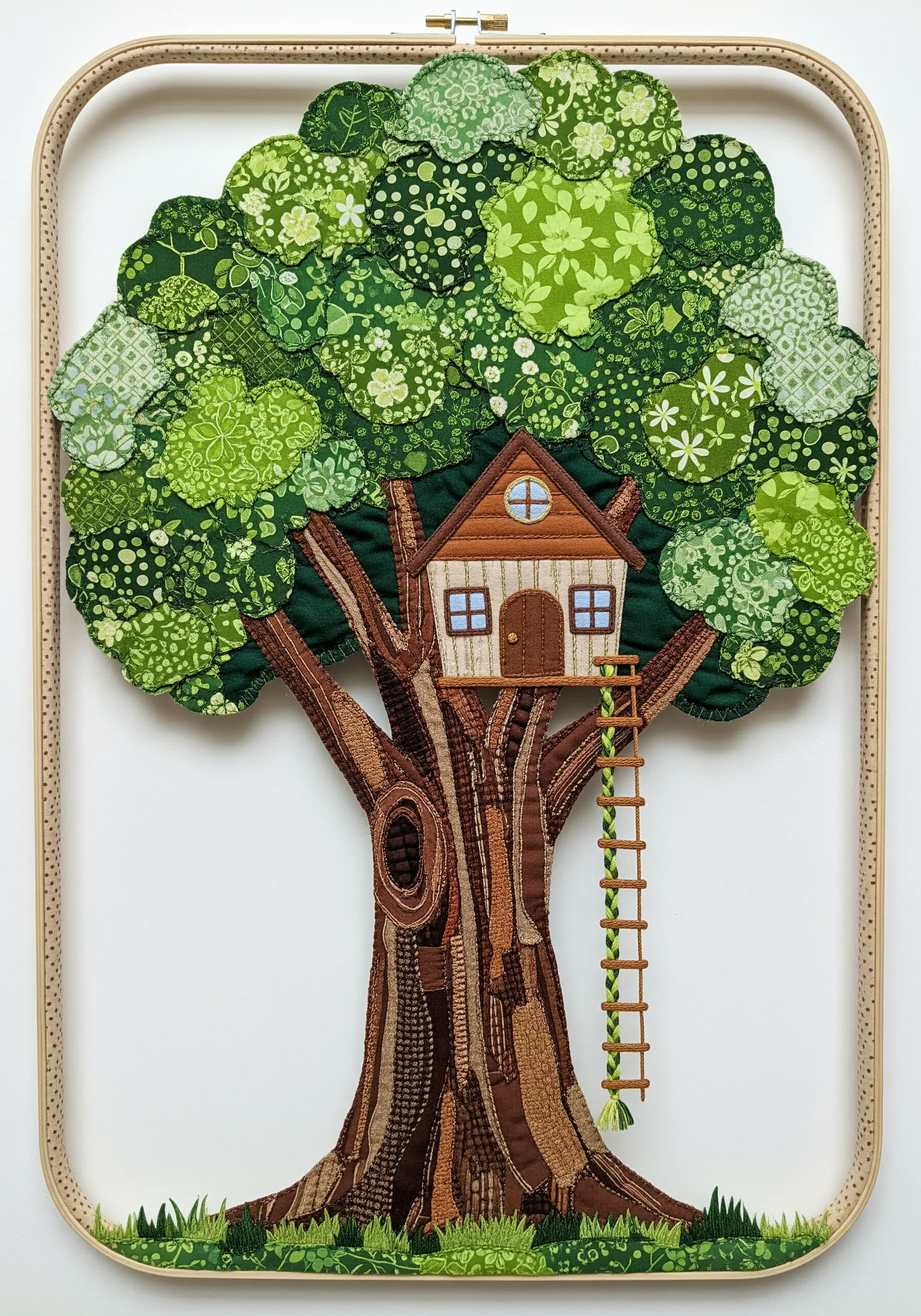 A fabric collage treehouse with a textured trunk and a canopy of green patterned fabrics.