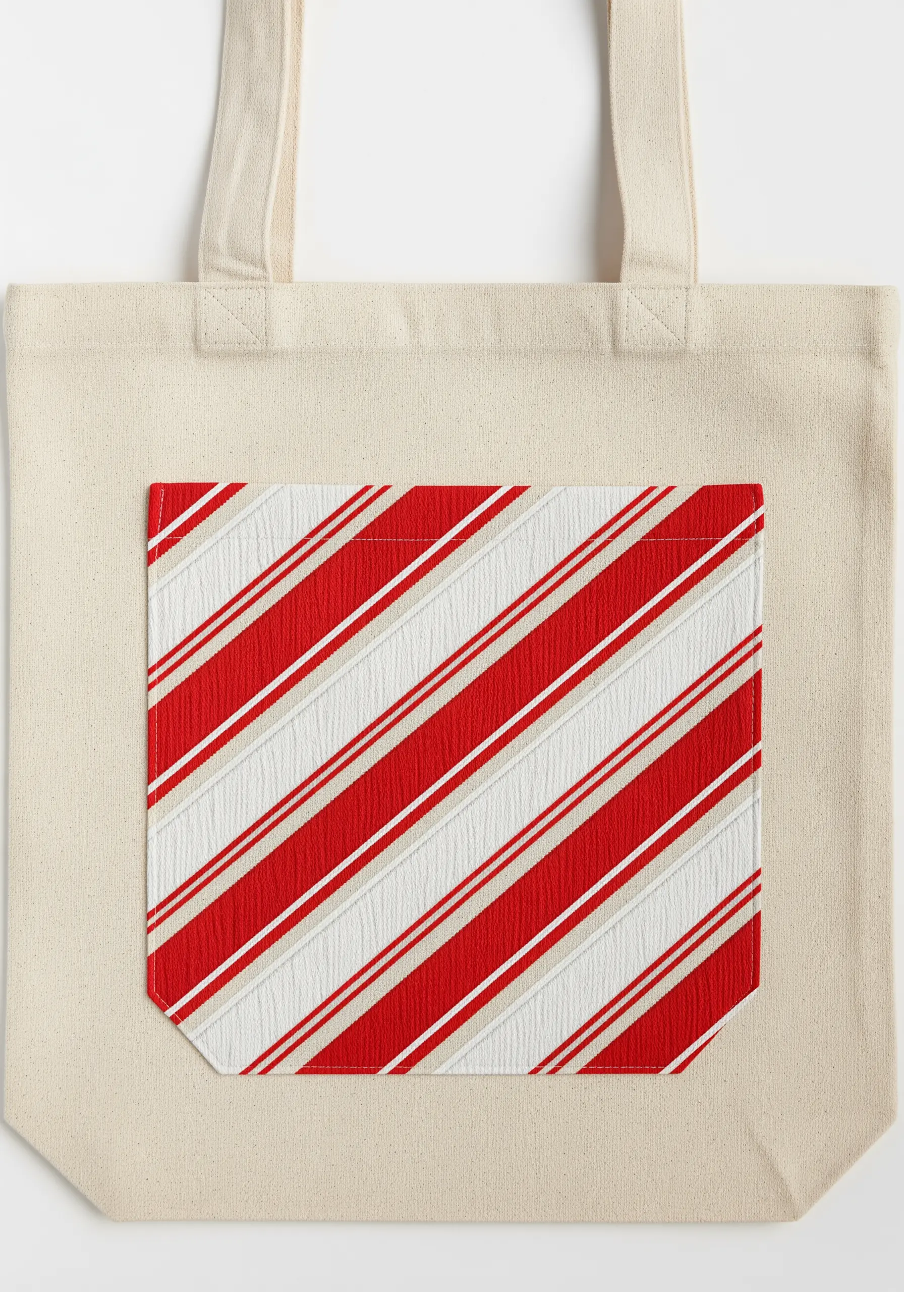 A tote bag pocket embroidered with diagonal red, white, and beige stripes to look like candy cane.