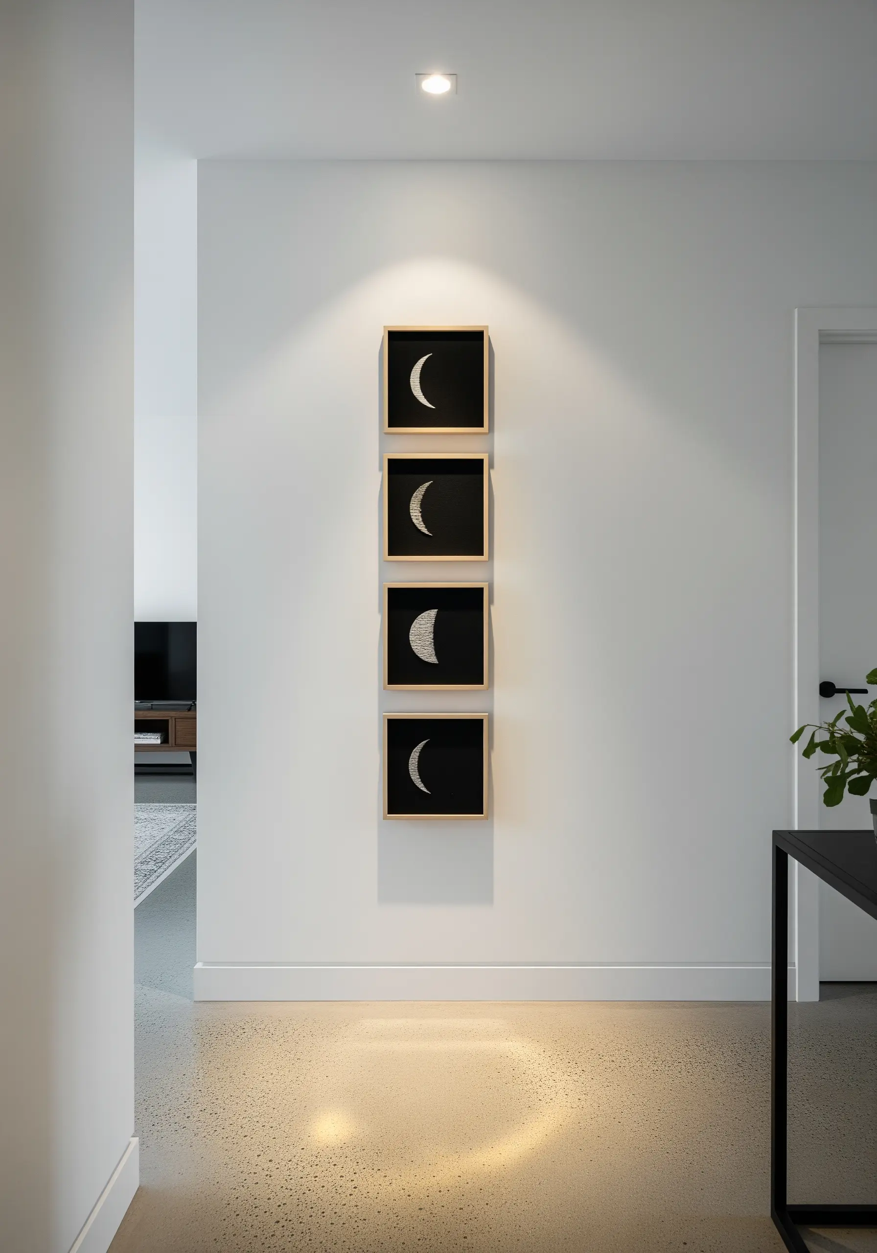 Four framed embroidery pieces showing moon phases on black fabric.
