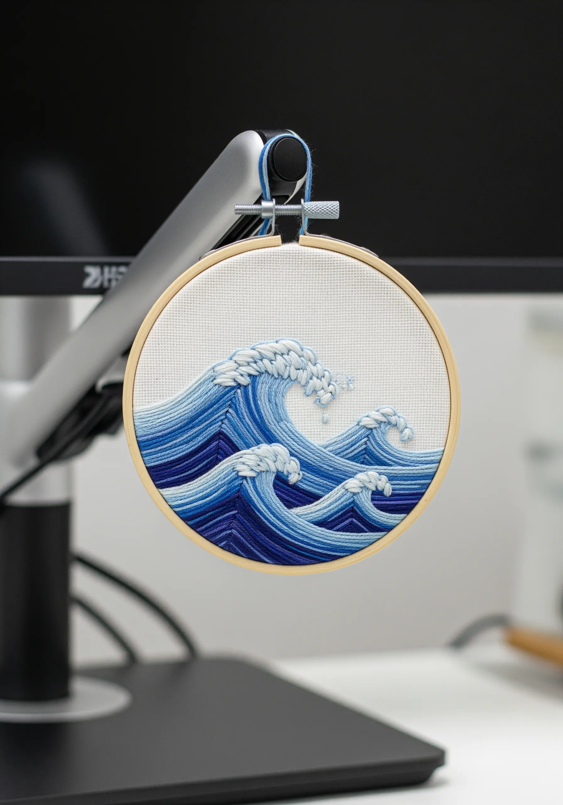 Embroidered ocean waves using blue and white thread gradients to show movement.