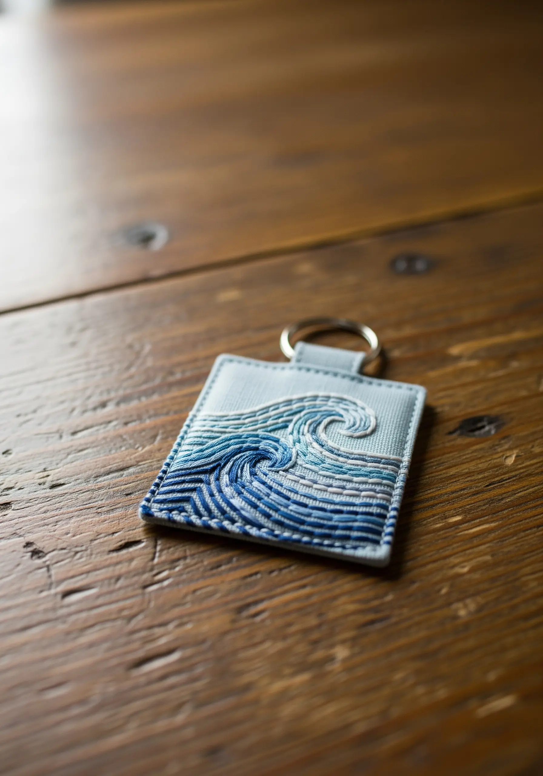 Embroidered ocean wave in shades of blue using varied stitch textures