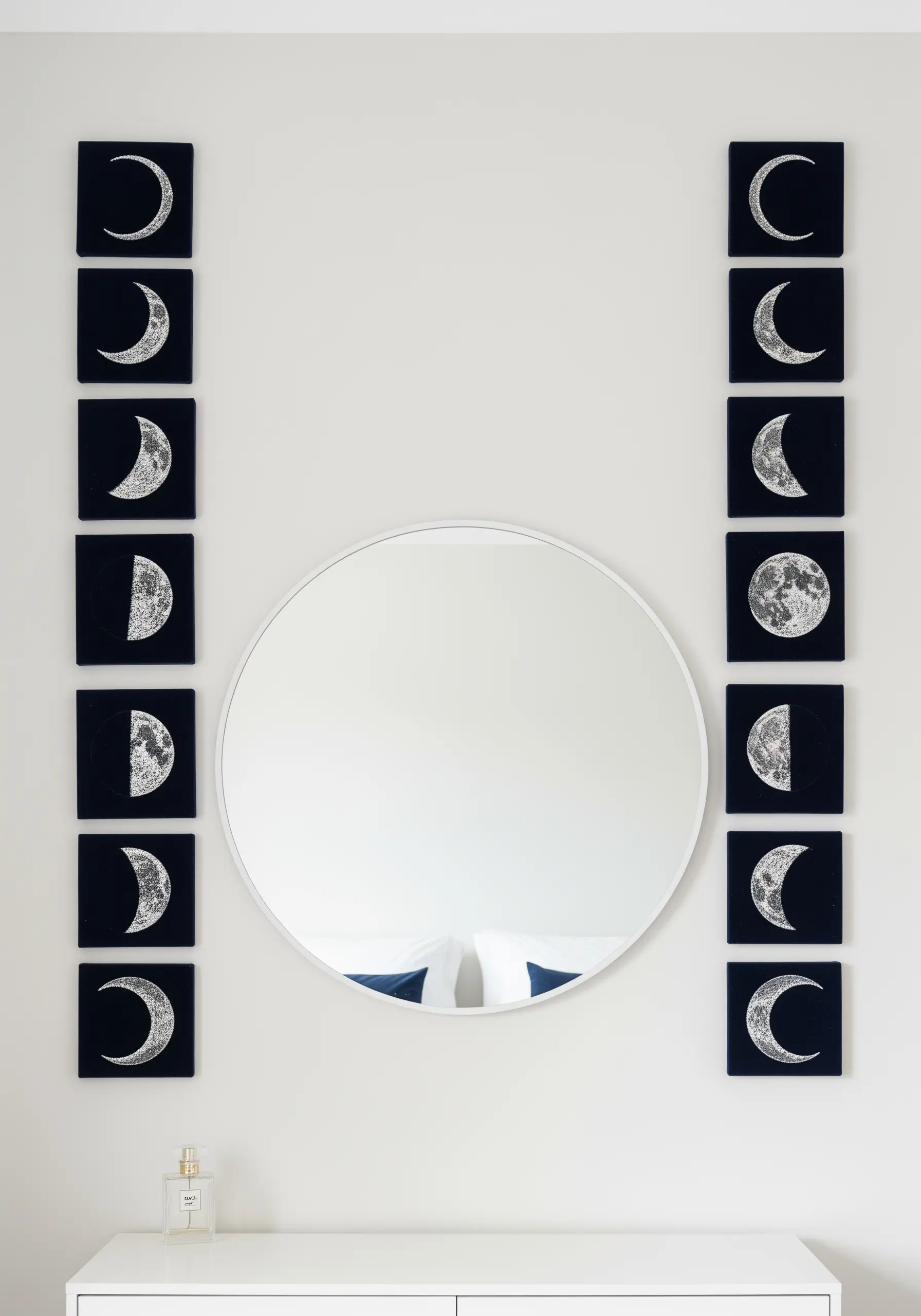 Vertical columns of moon phase embroidery flanking a round mirror