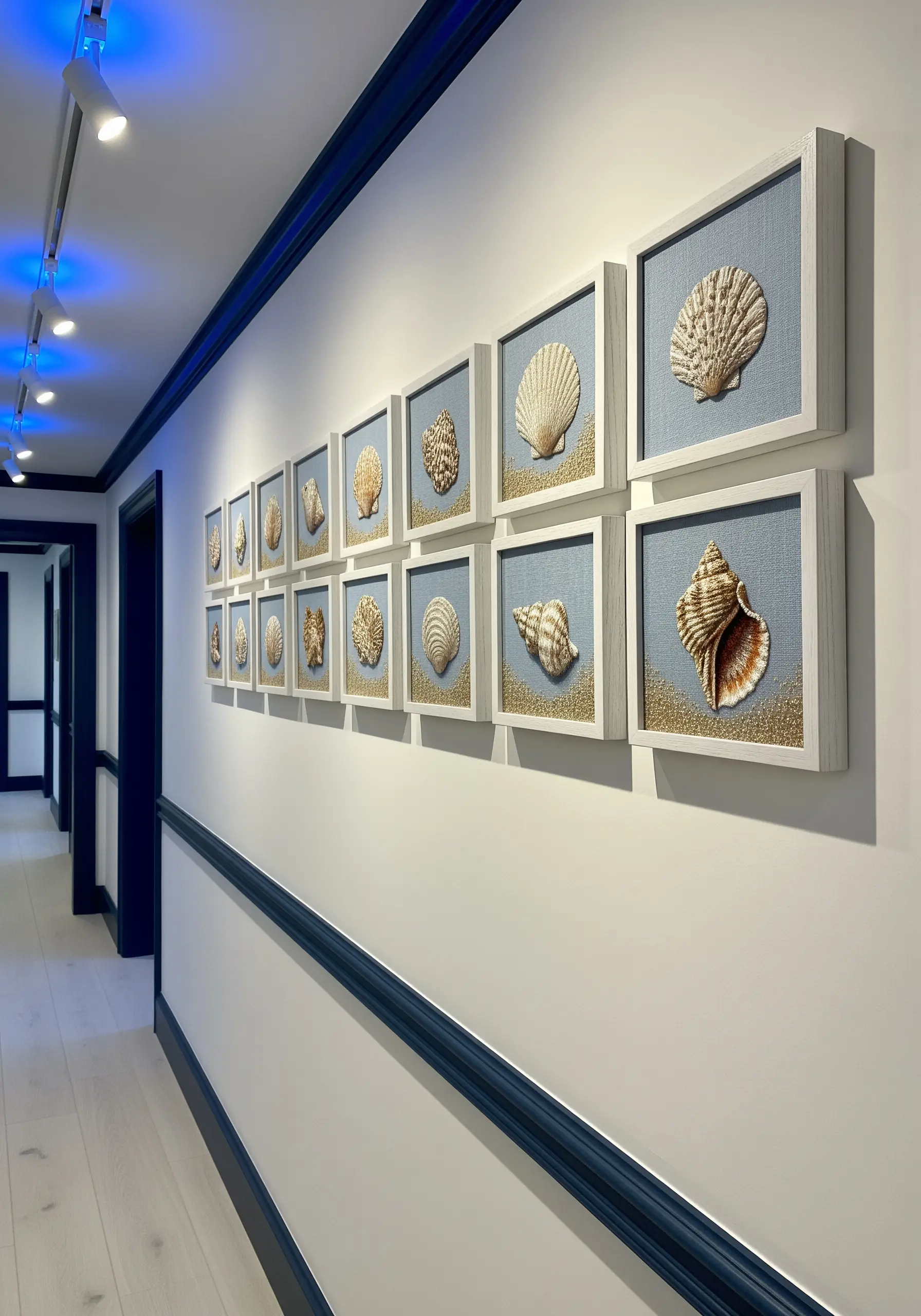 A long hallway wall with a grid of framed, three-dimensional seashell embroideries.