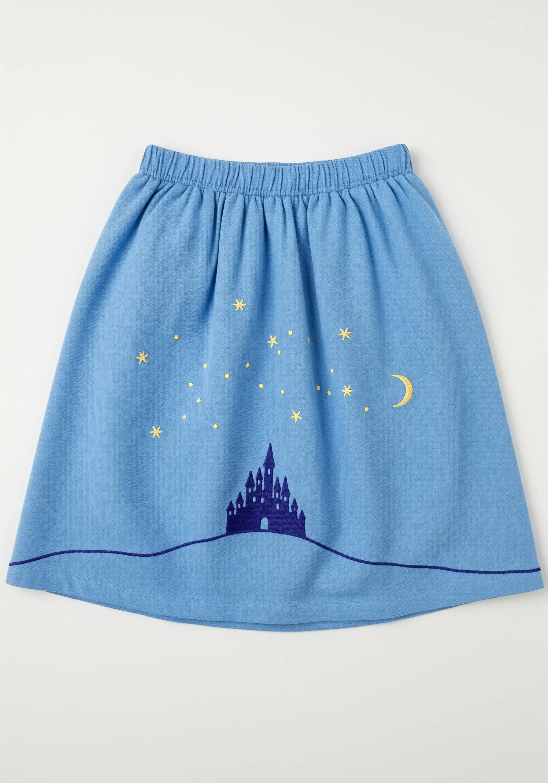 A simple appliqué castle silhouette with embroidered stars on a light blue skirt.