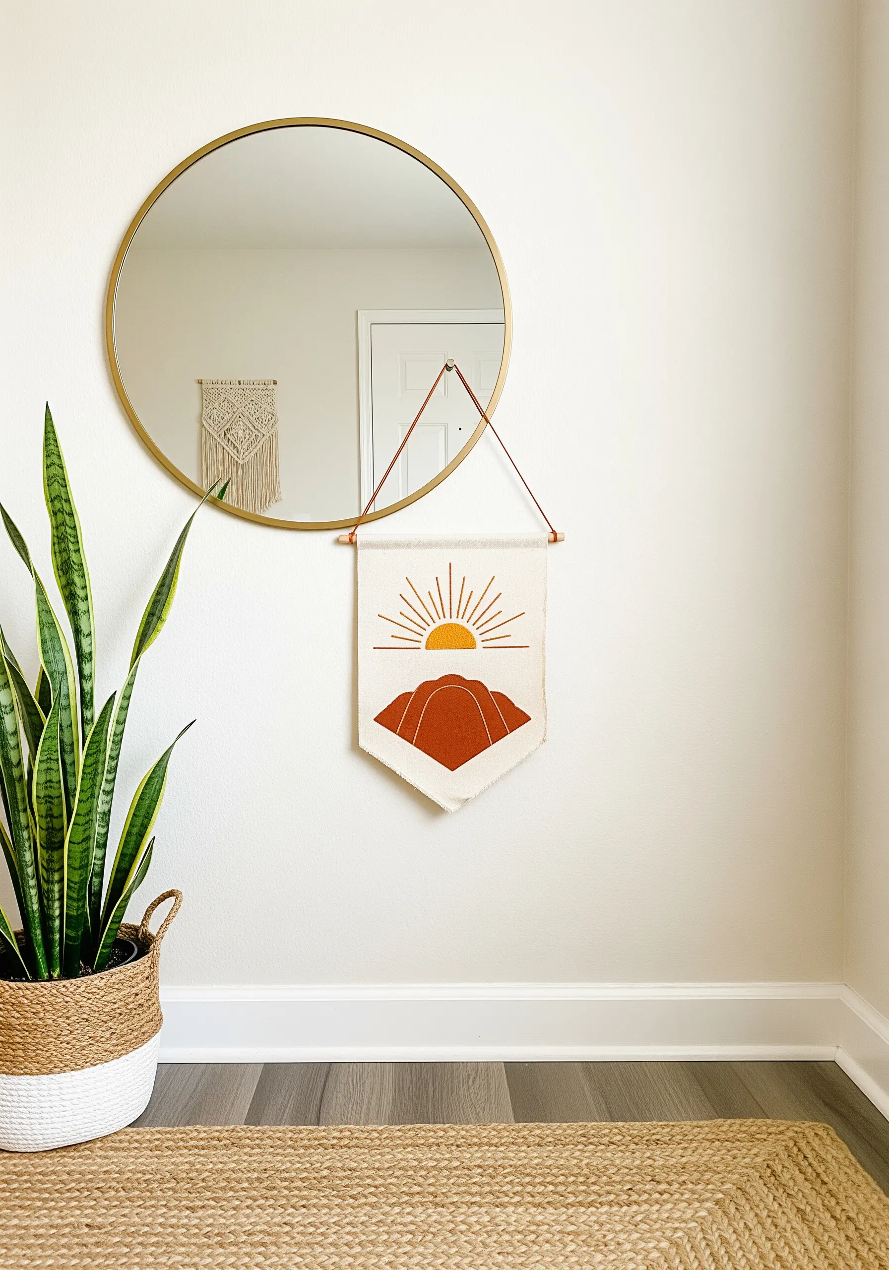 A wall banner combining a rust-colored fabric appliqué with embroidered sun rays.