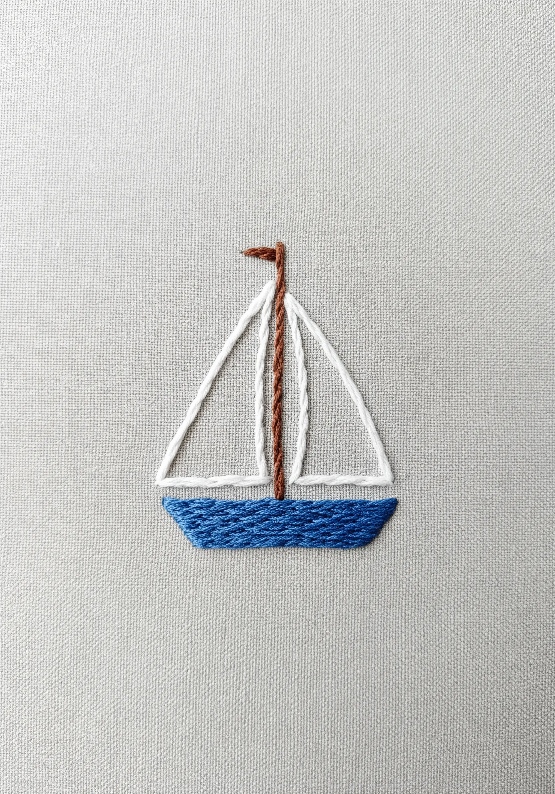 A minimalist sailboat with a blue satin-stitched hull and white outlined sails.