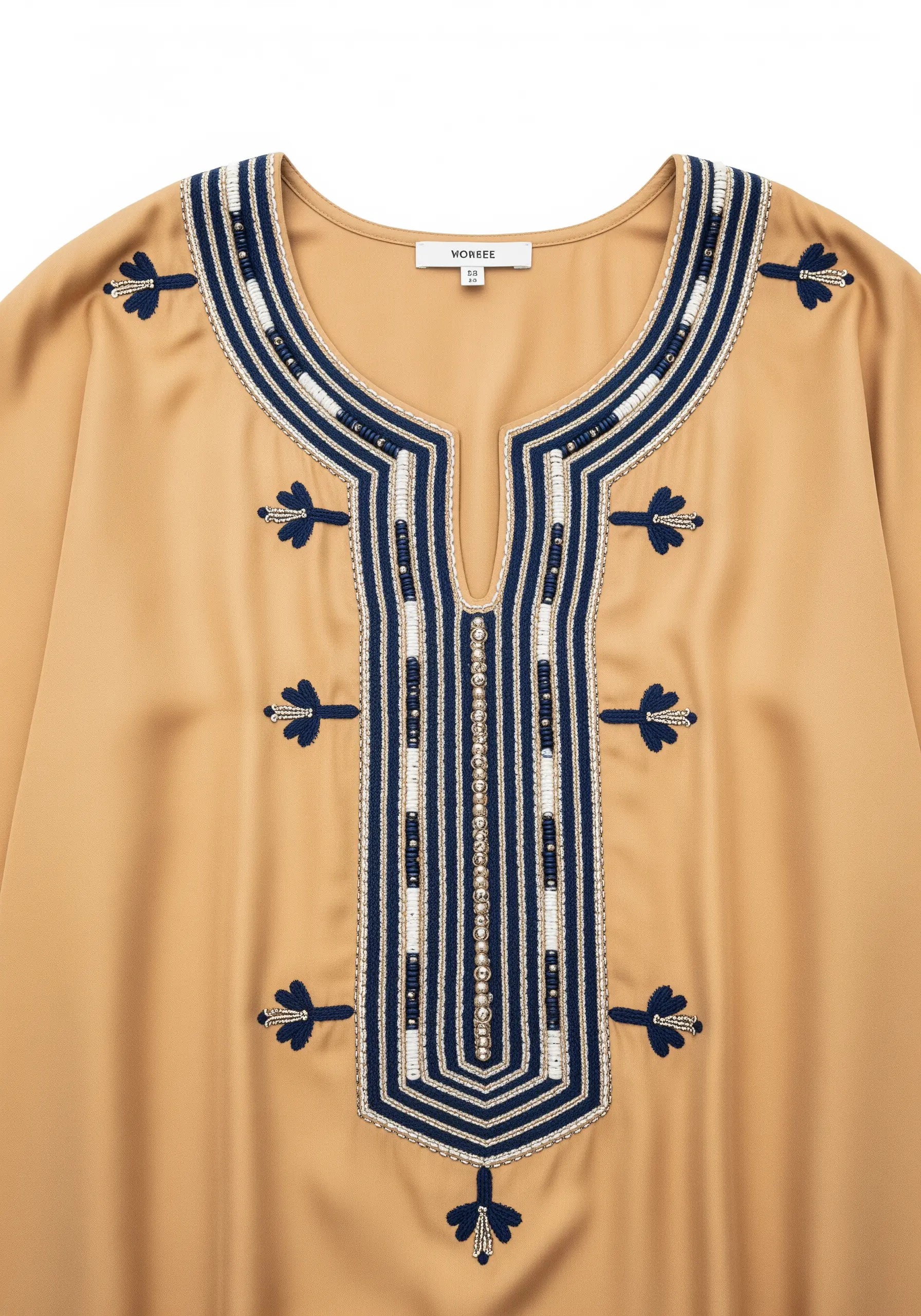 Intricate neckline embroidery on a gold caftan, combining navy thread with rows of white beads.