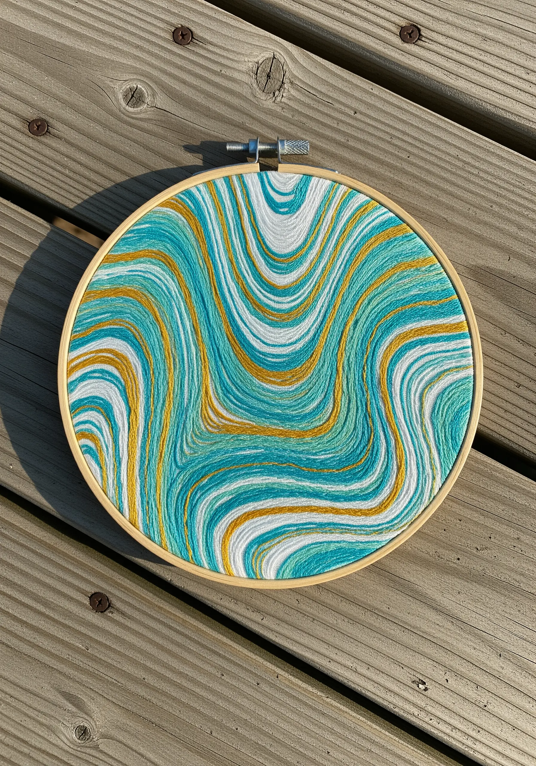 Psychedelic swirling teal and gold embroidery pattern
