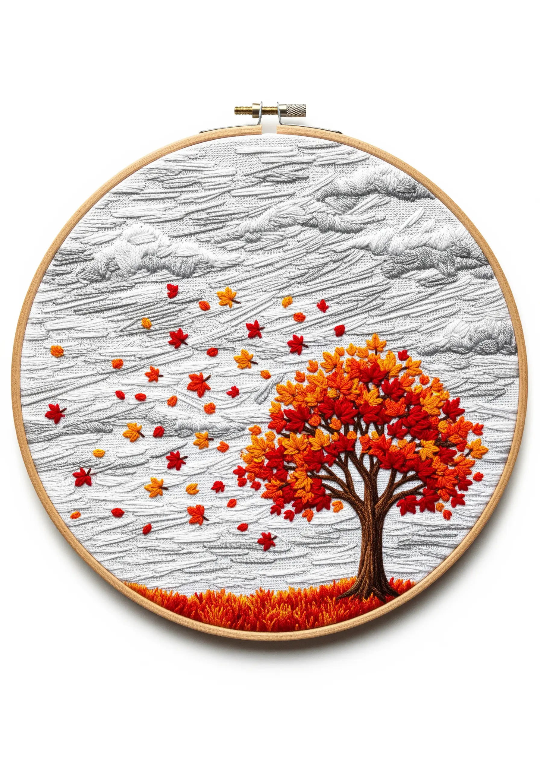 Autumn tree with wind-blown leaves and grey textured sky