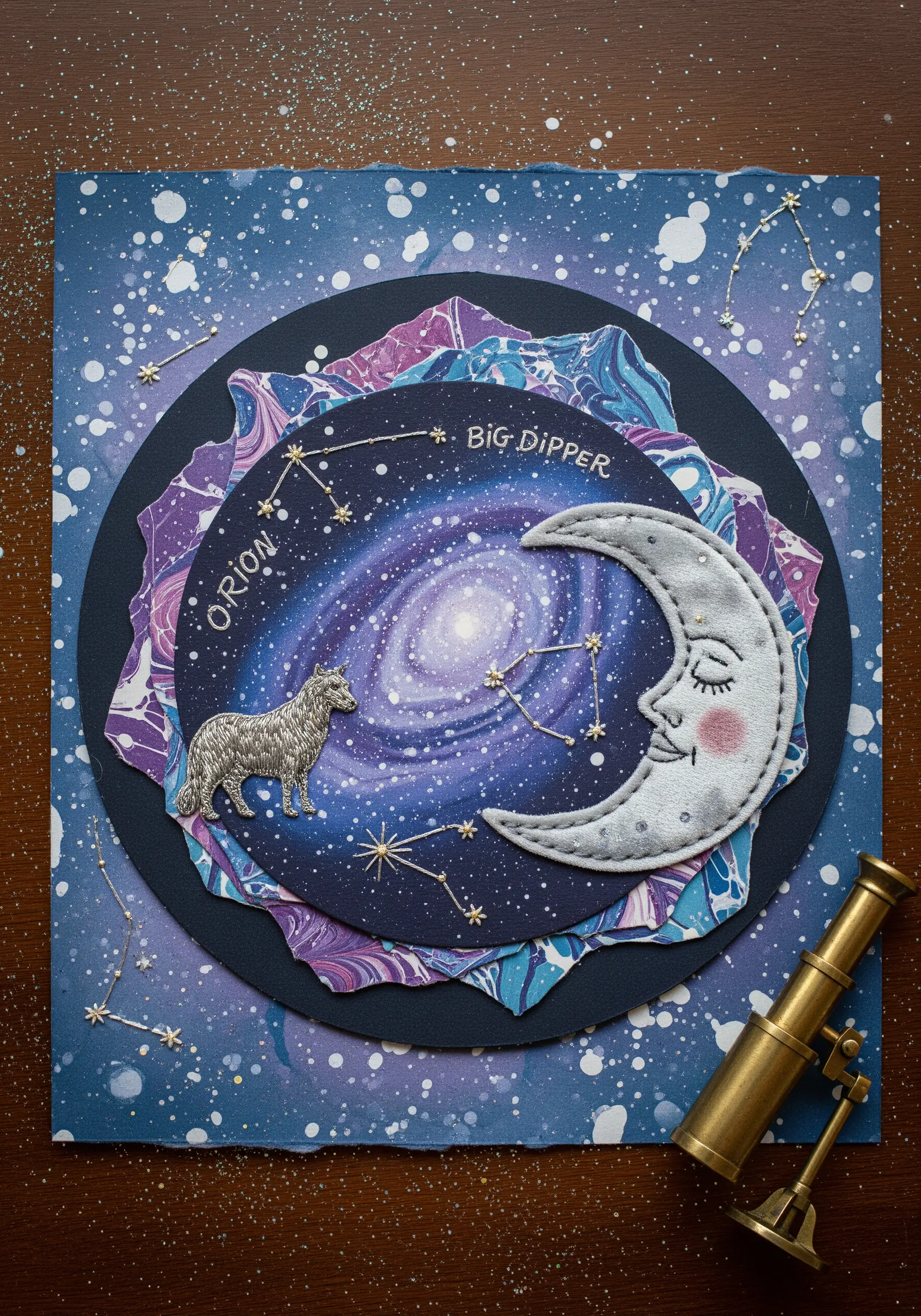 A cosmic collage with marbled paper, an embroidered moon appliqué, and stitched constellations.