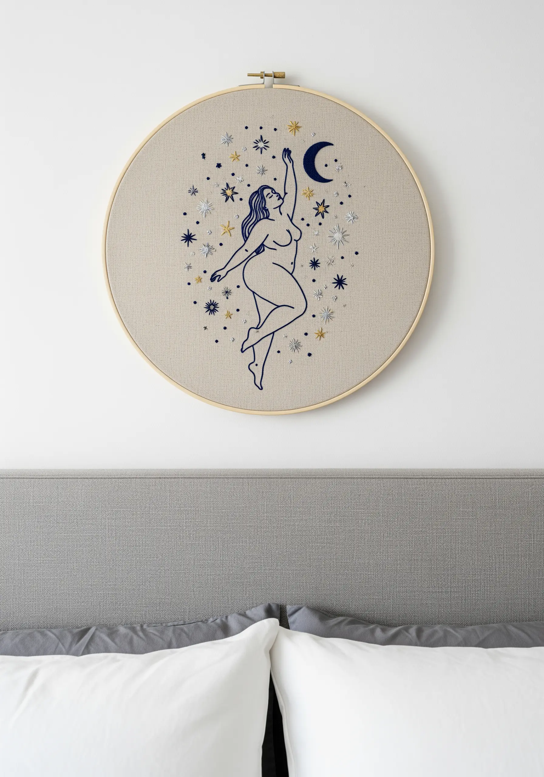 A female figure reaching for an embroidered moon and stars in metallic threads.