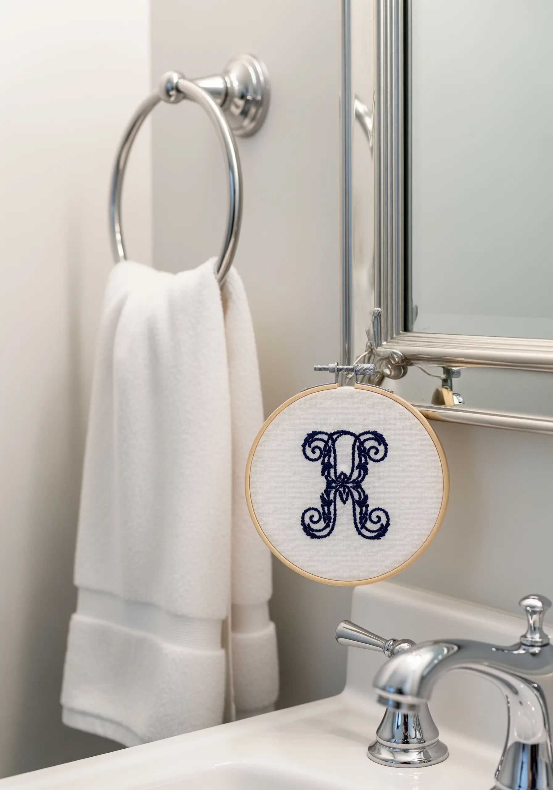 A classic, bold navy blue monogram embroidered with dense satin stitch.