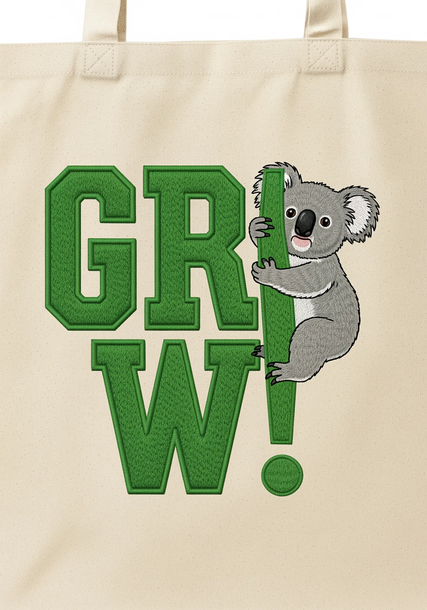 The word 'GROW!' embroidered in bold green satin stitch, with a koala climbing the exclamation mark.