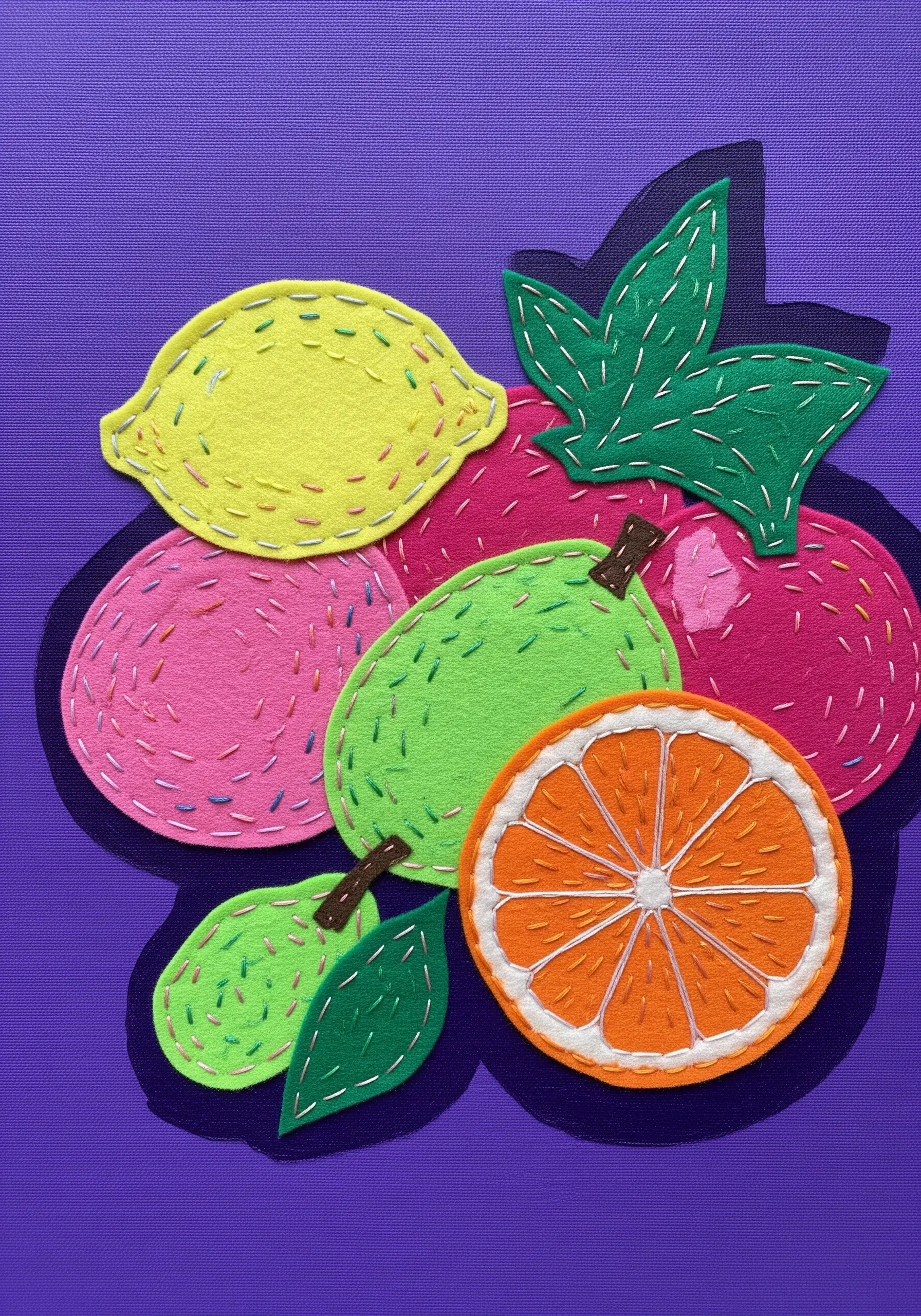 A vibrant still life of citrus fruits made from layered felt and simple running stitches.