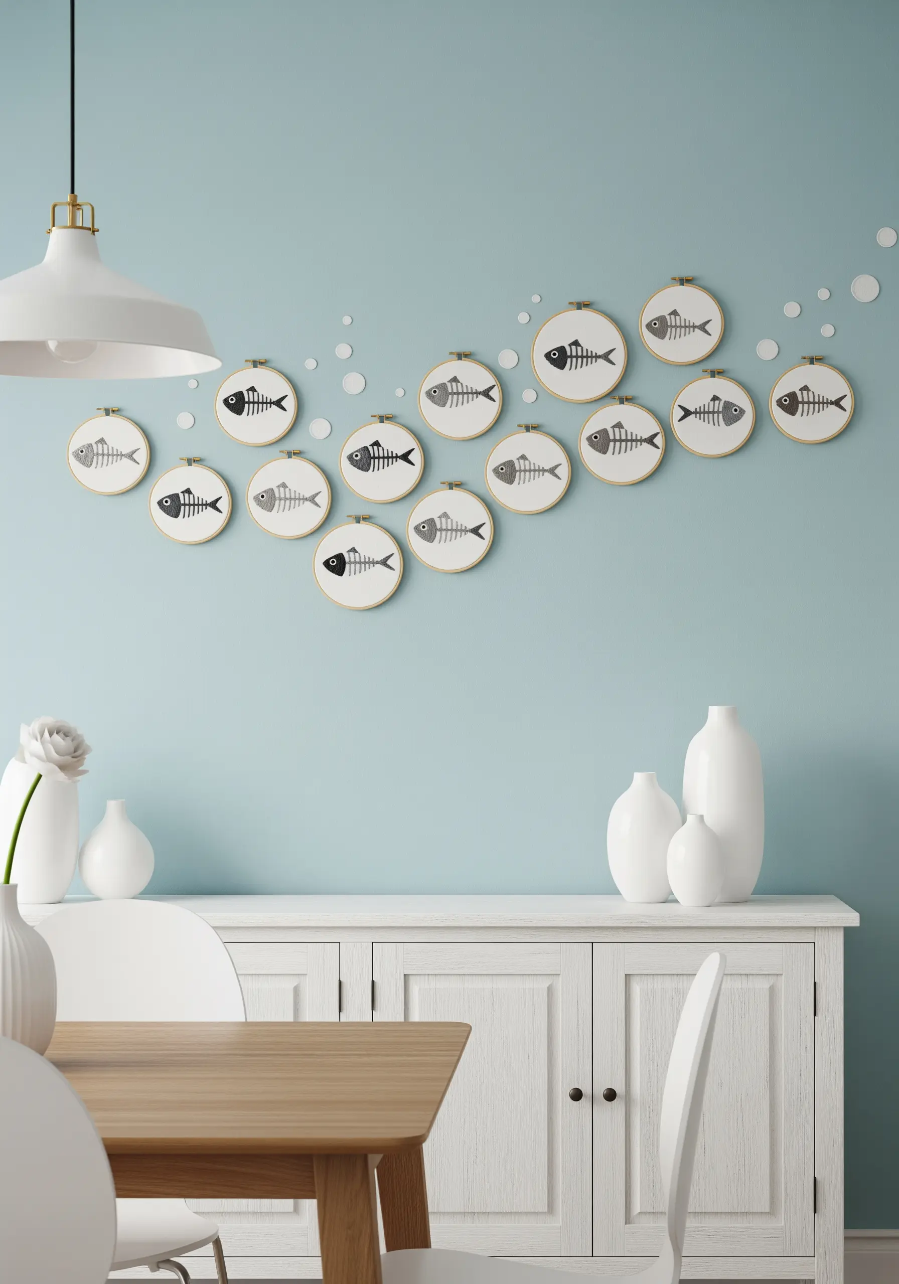 A school of embroidered fish skeletons in hoops arranged in a flowing wave pattern.