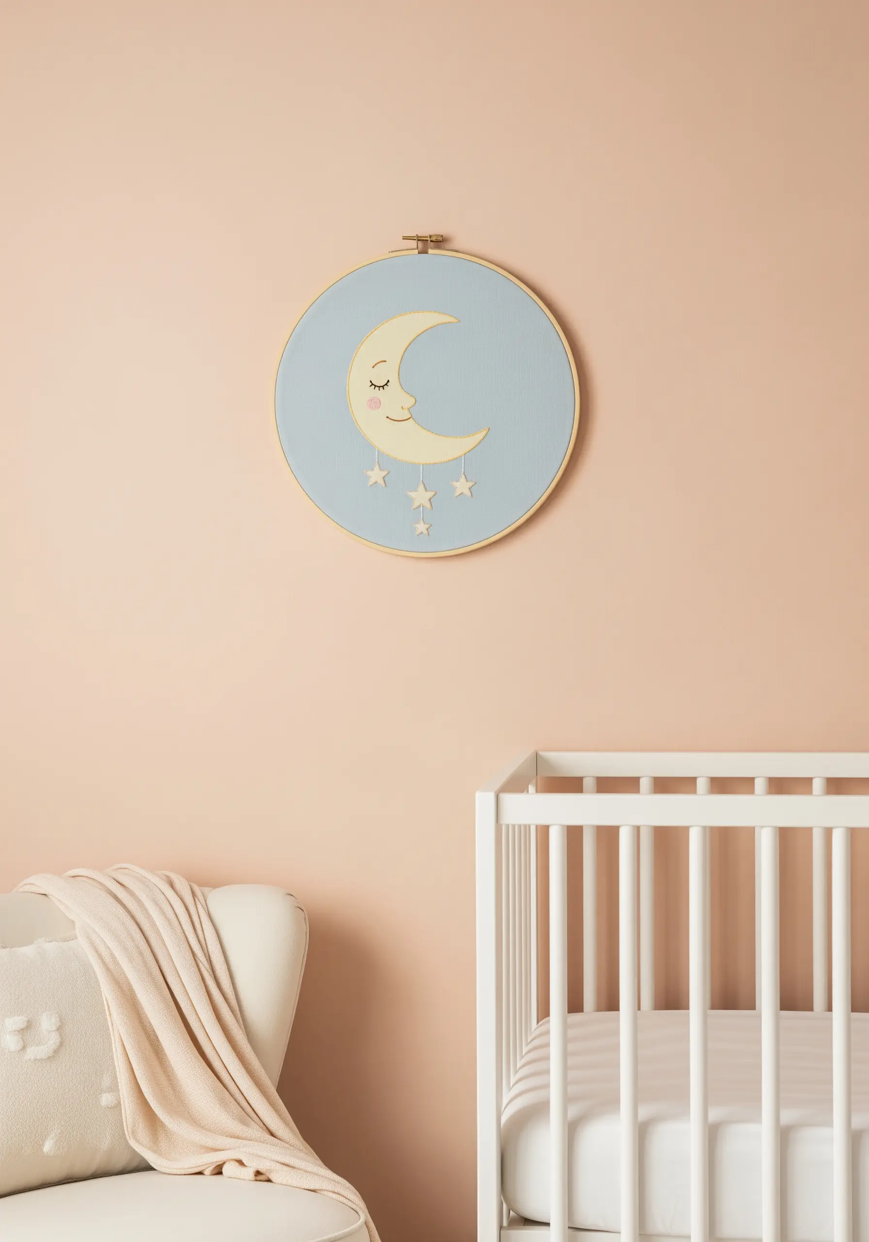 A sweet embroidered sleeping moon with hanging stars in a hoop for a nursery.