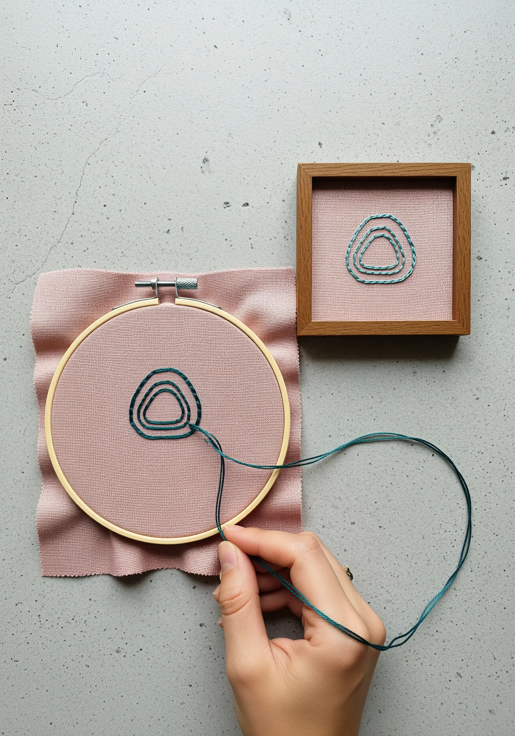 Abstract concentric rings stitched with blended teal and green threads.