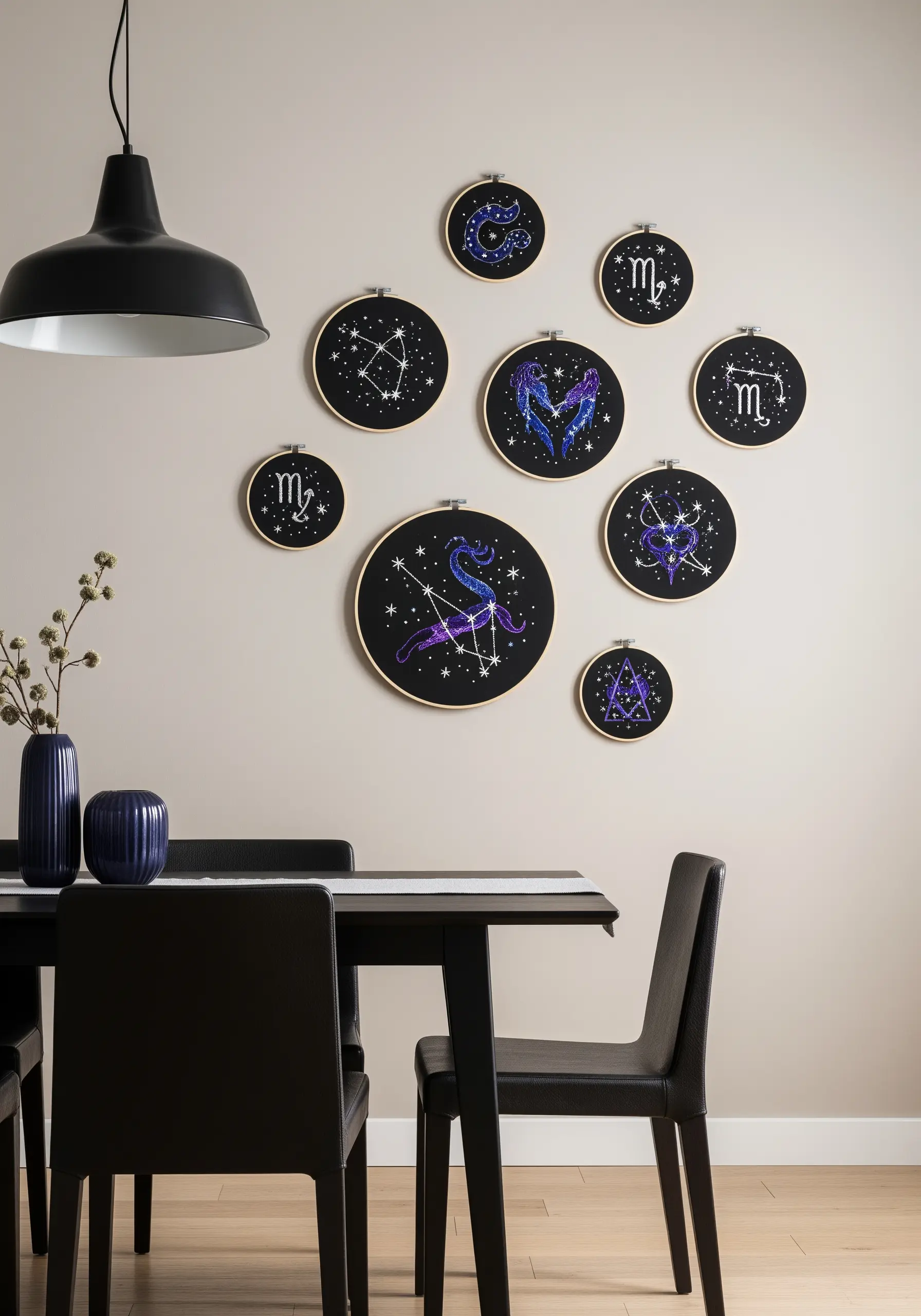 Zodiac constellation embroidery hoops in blues and purples on black fabric.