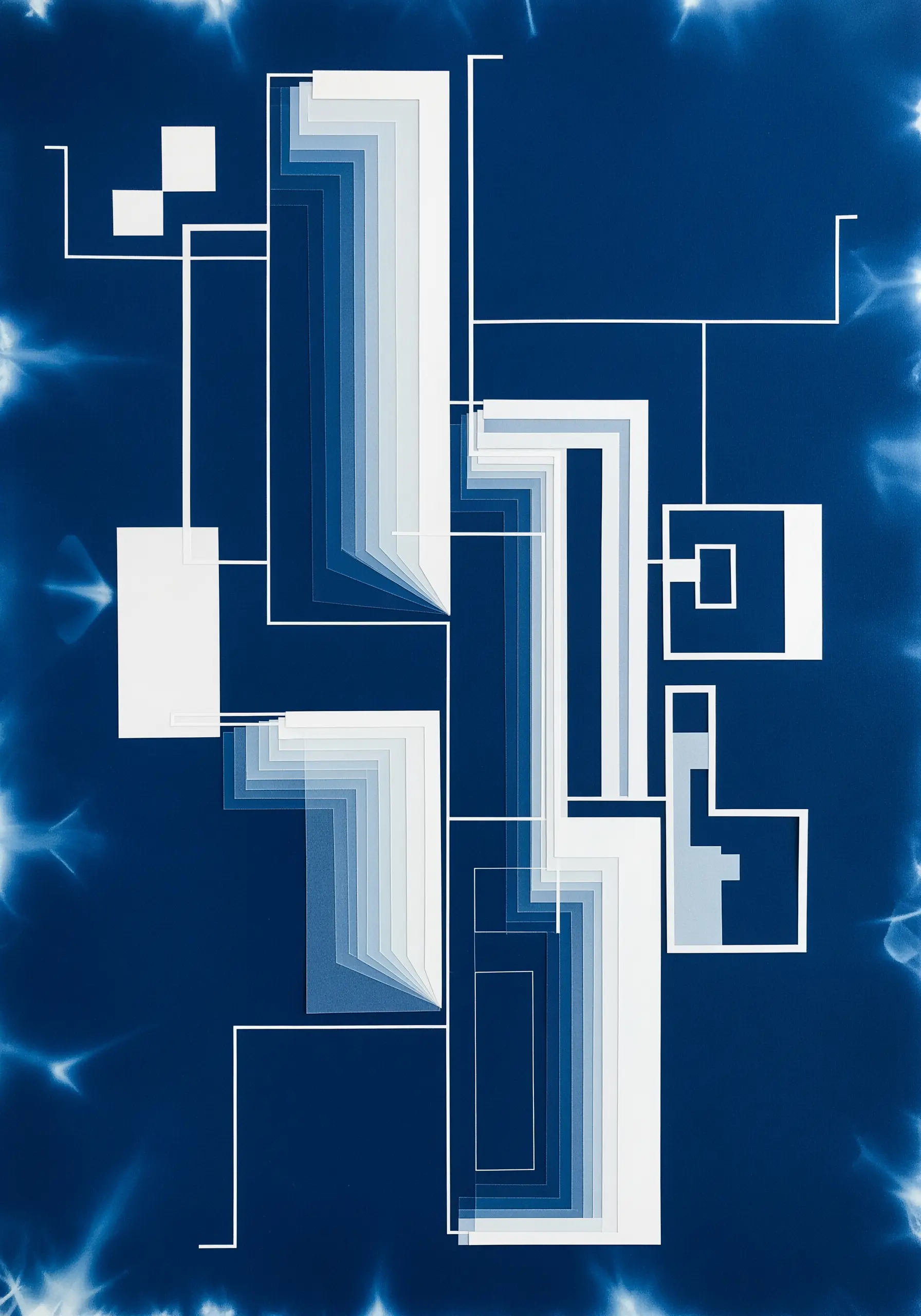 Abstract geometric paper collage in shades of blue with clean, white lines.