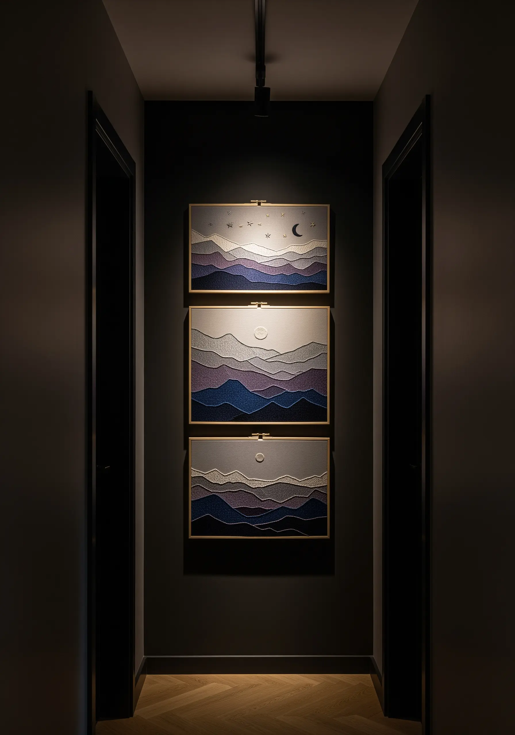 Three rectangular embroidery hoops with layered mountain landscapes in shades of purple and blue.