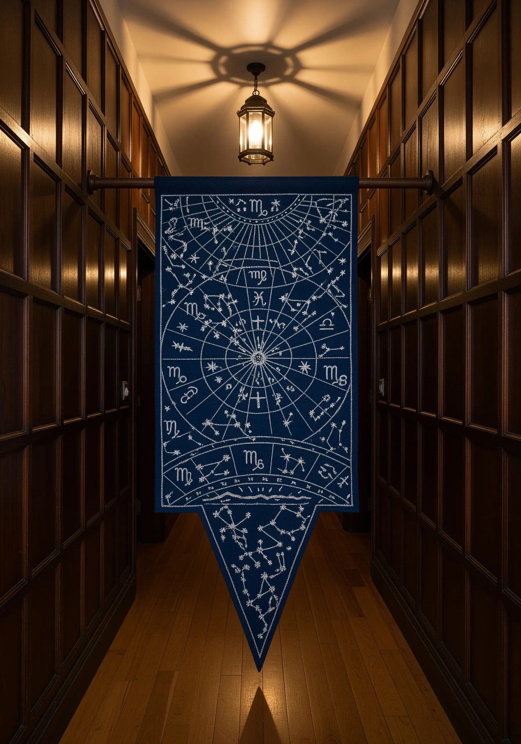 An embroidered celestial map with constellations and zodiac signs on a navy blue banner.