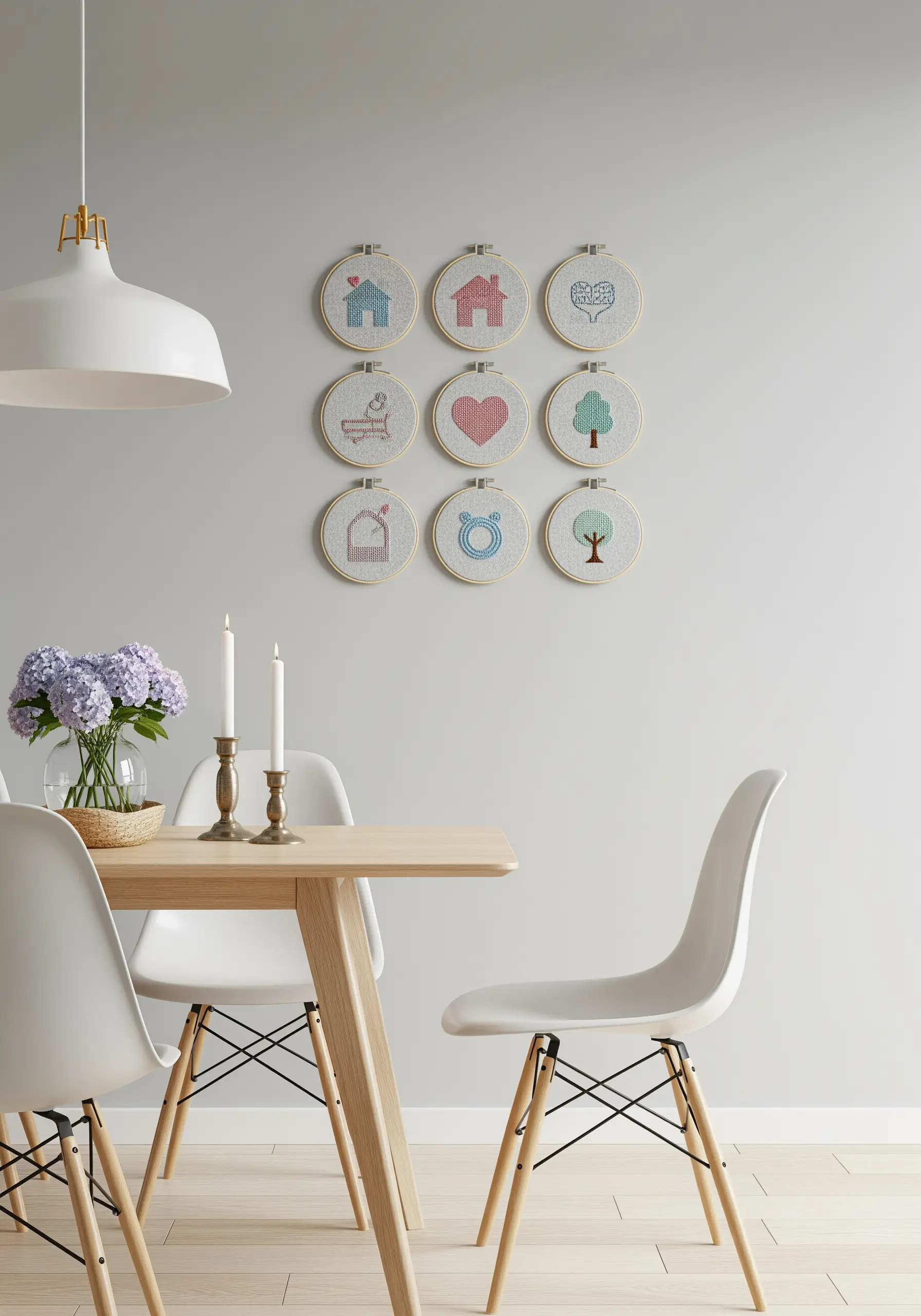 A grid of nine small hoops with icons stitched in soft pink and blue.