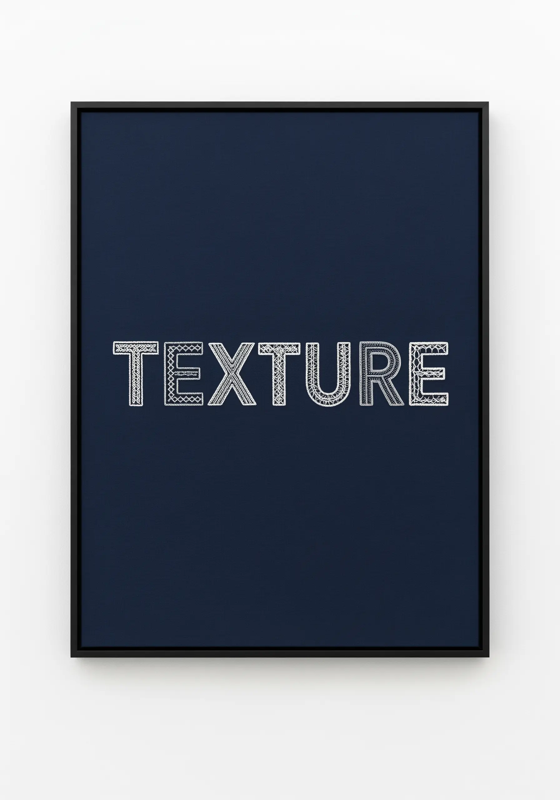 The word “TEXTURE” filled with delicate, lace-like white stitching on a dark navy background.