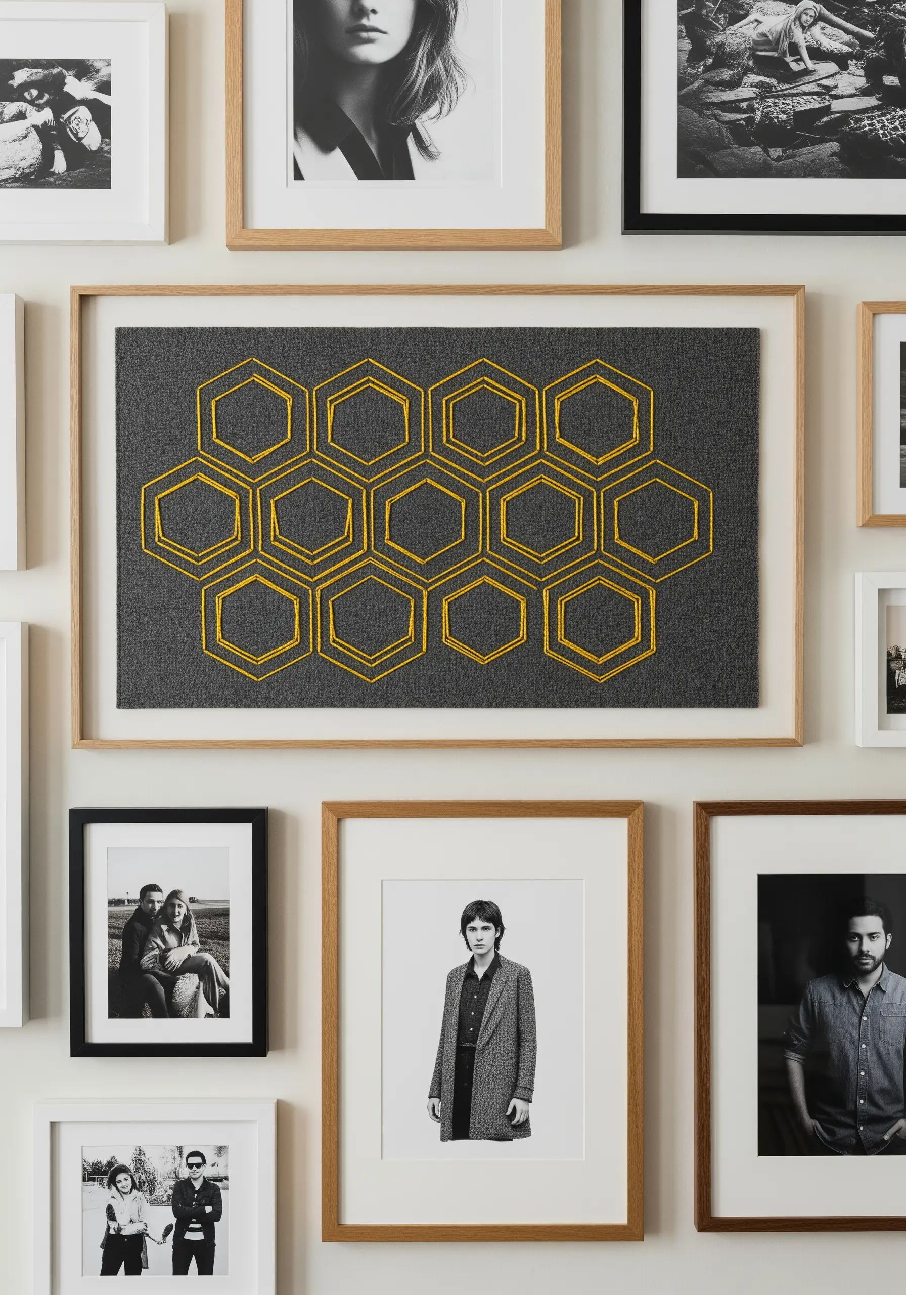 A geometric honeycomb pattern embroidered in yellow thread on dark grey felt.