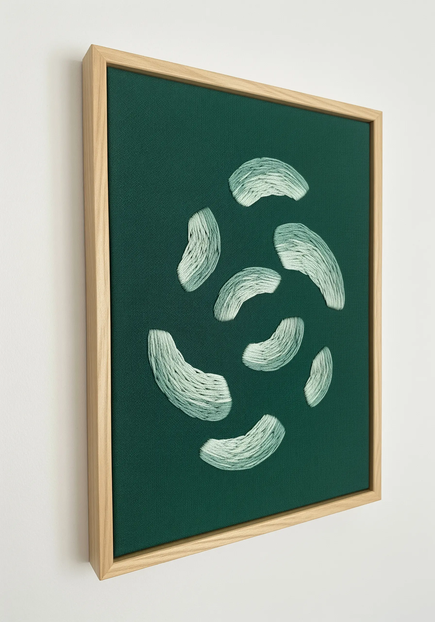 Scattered, curved satin stitches in mint green on a dark teal canvas.