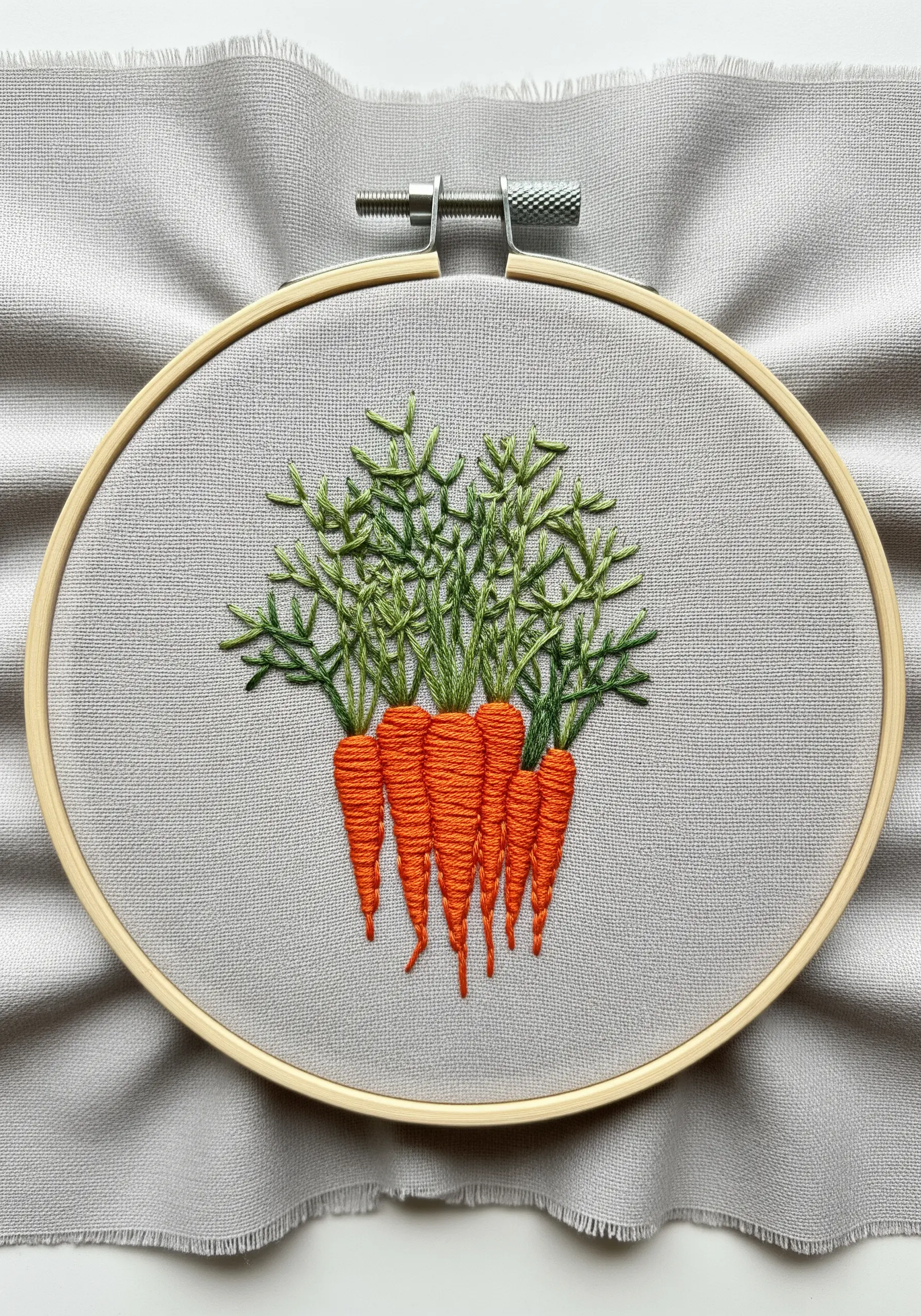 A bunch of embroidered carrots with textured orange bodies and bushy green tops.