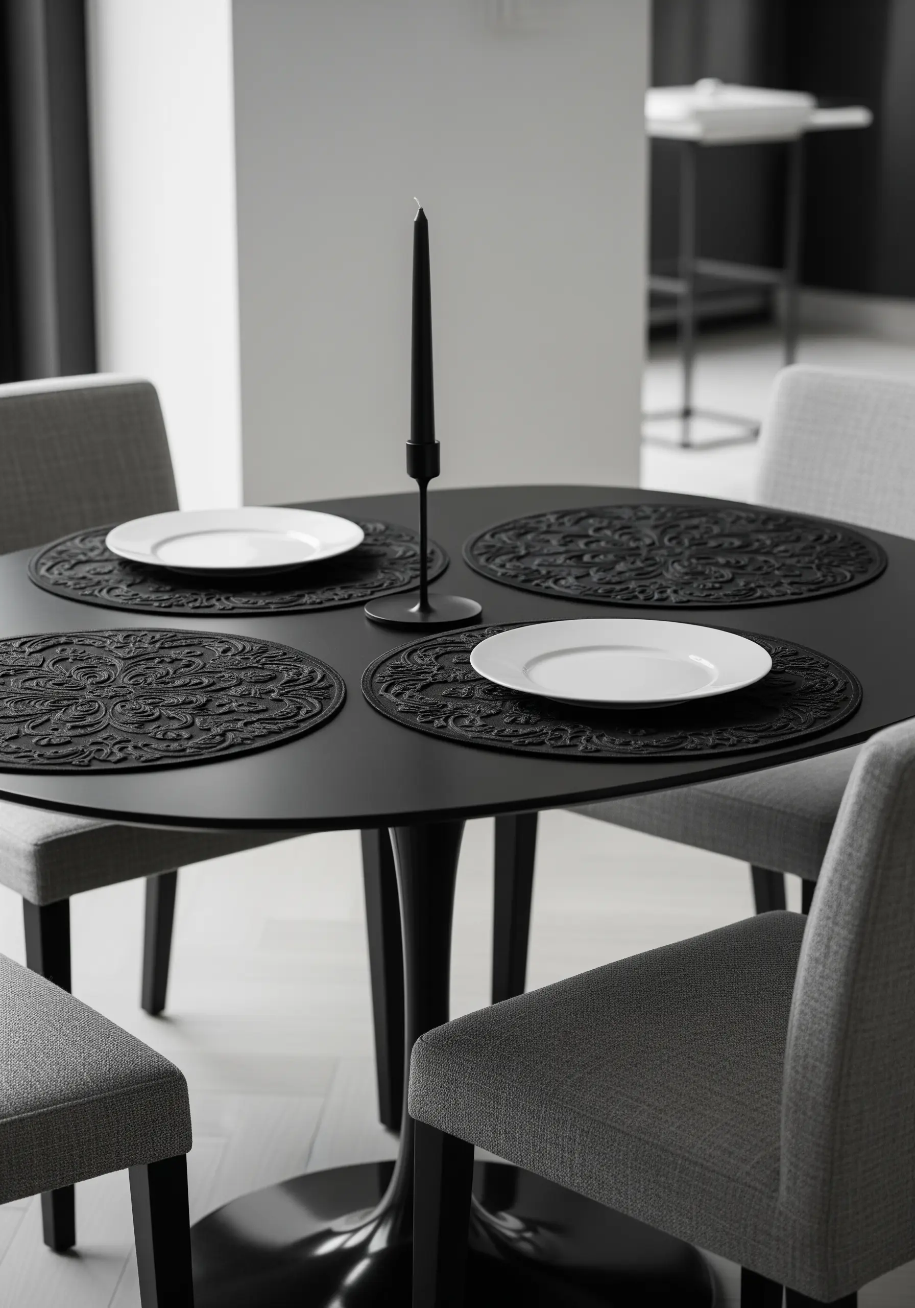 Black-on-black embroidered placemats with a textured, intricate damask pattern