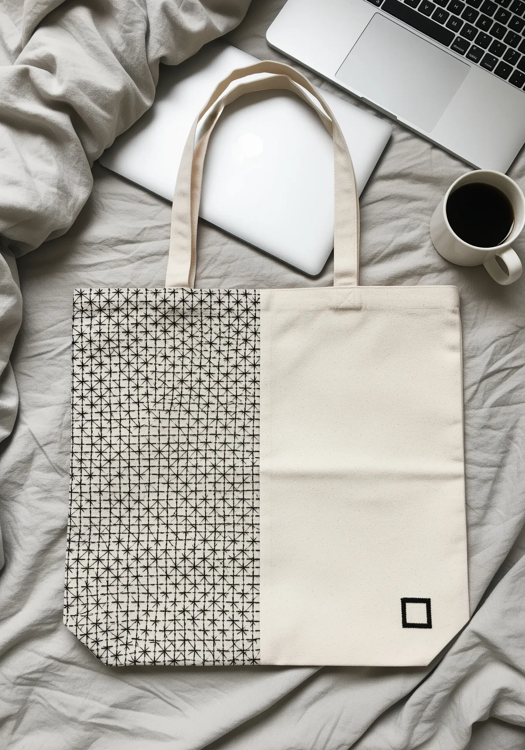 A tote bag split in half: one side is covered in a dense star stitch pattern, the other is plain.