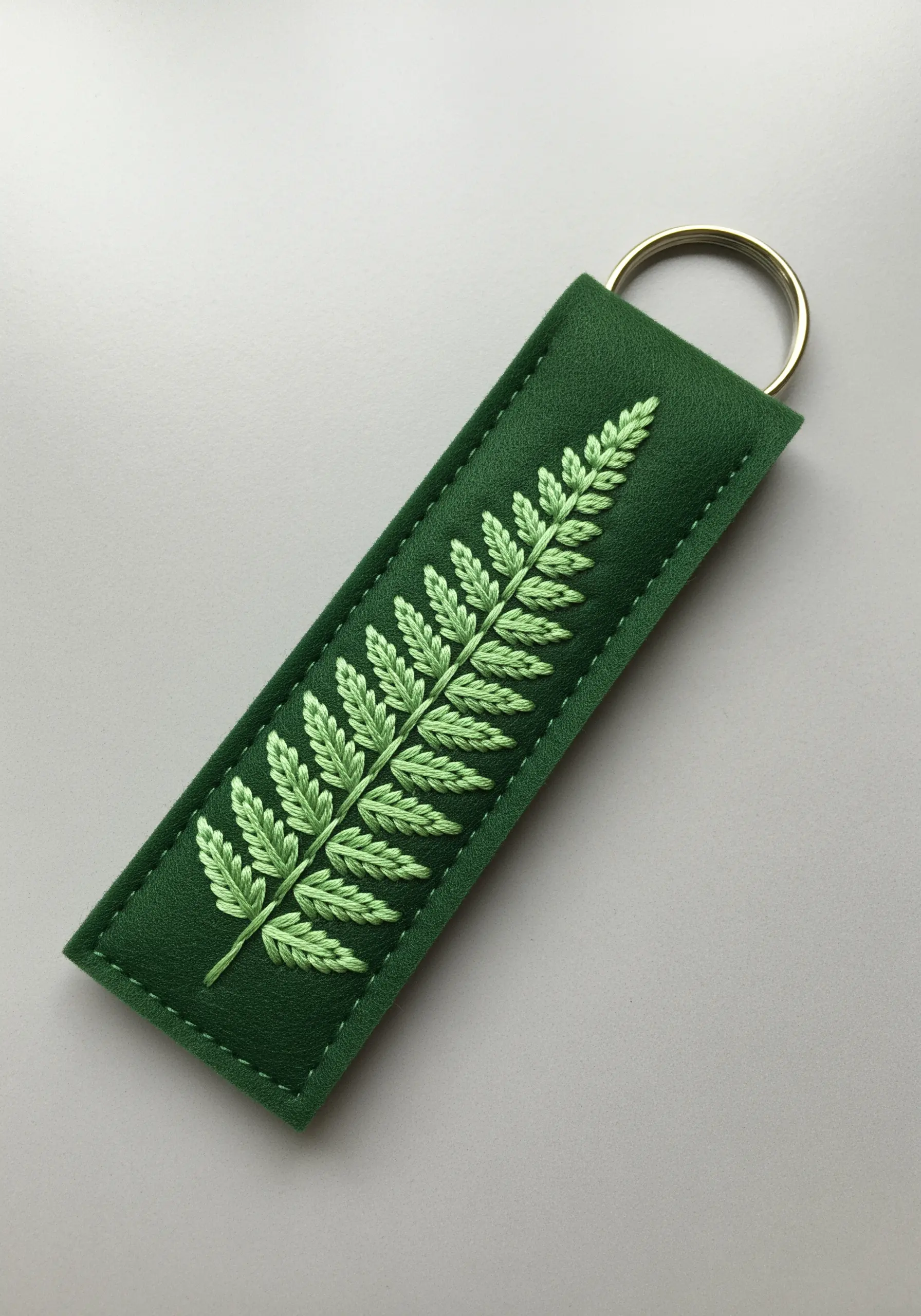 Delicate fern leaf embroidered with fly stitch in shades of green