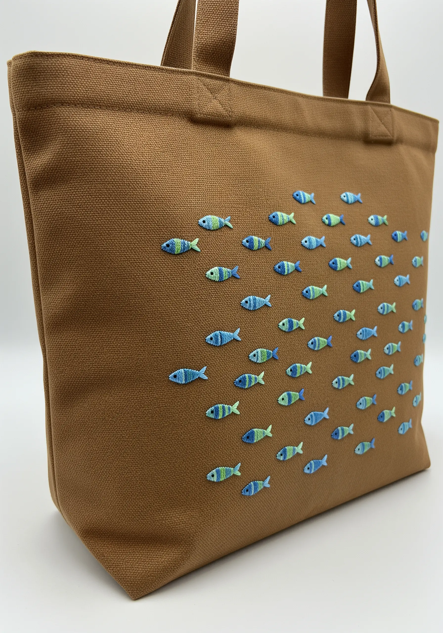 A school of tiny, colorful fish embroidered across a brown canvas tote bag.