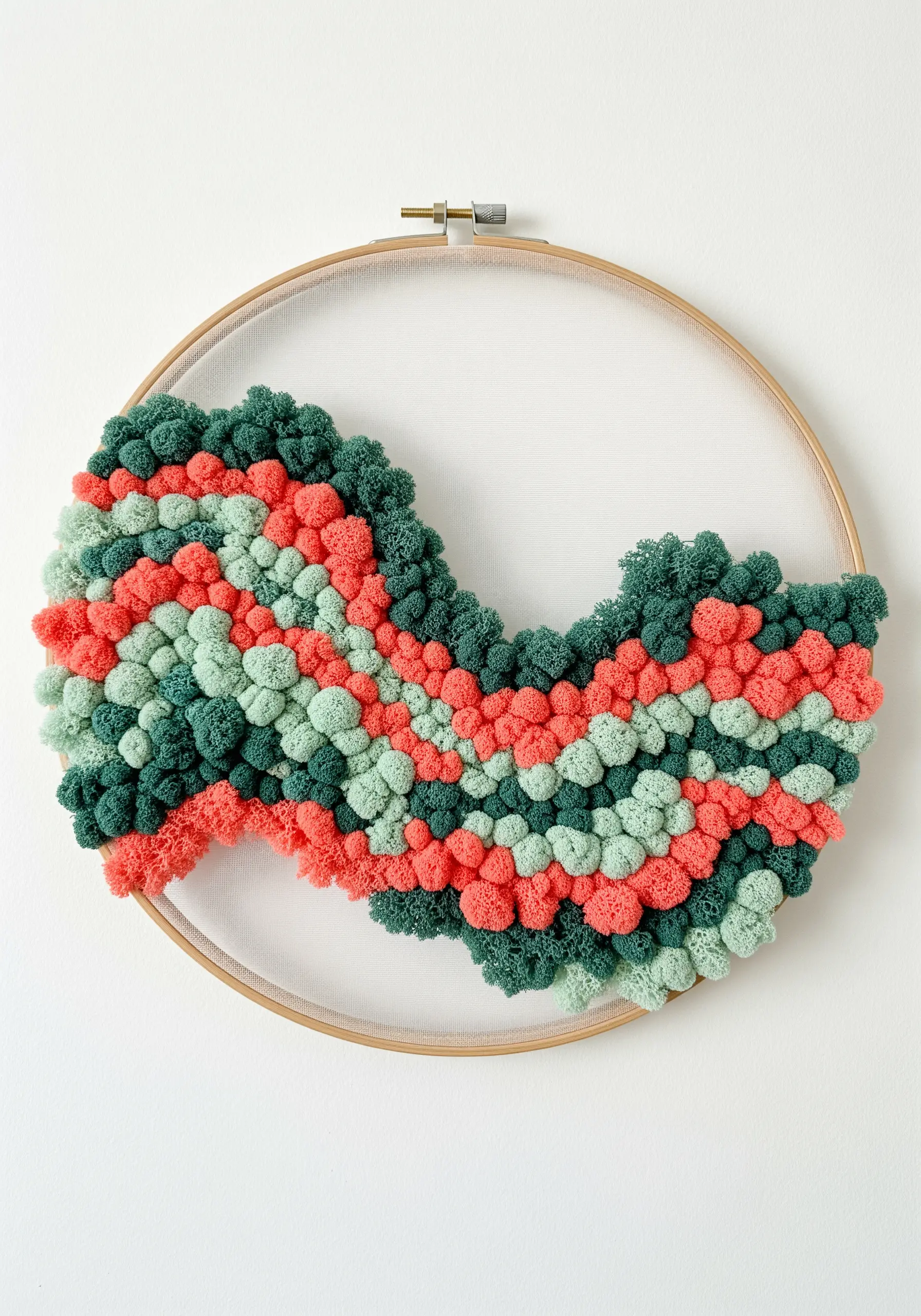 A dense cluster of coral, mint, and green Turkey work stitches forming a wavy, textured shape.