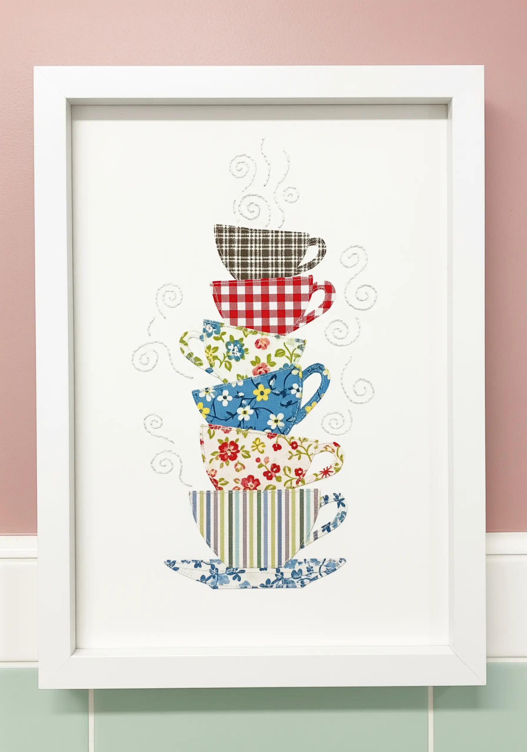 A stack of teacups made from a collage of different patterned fabric scraps.