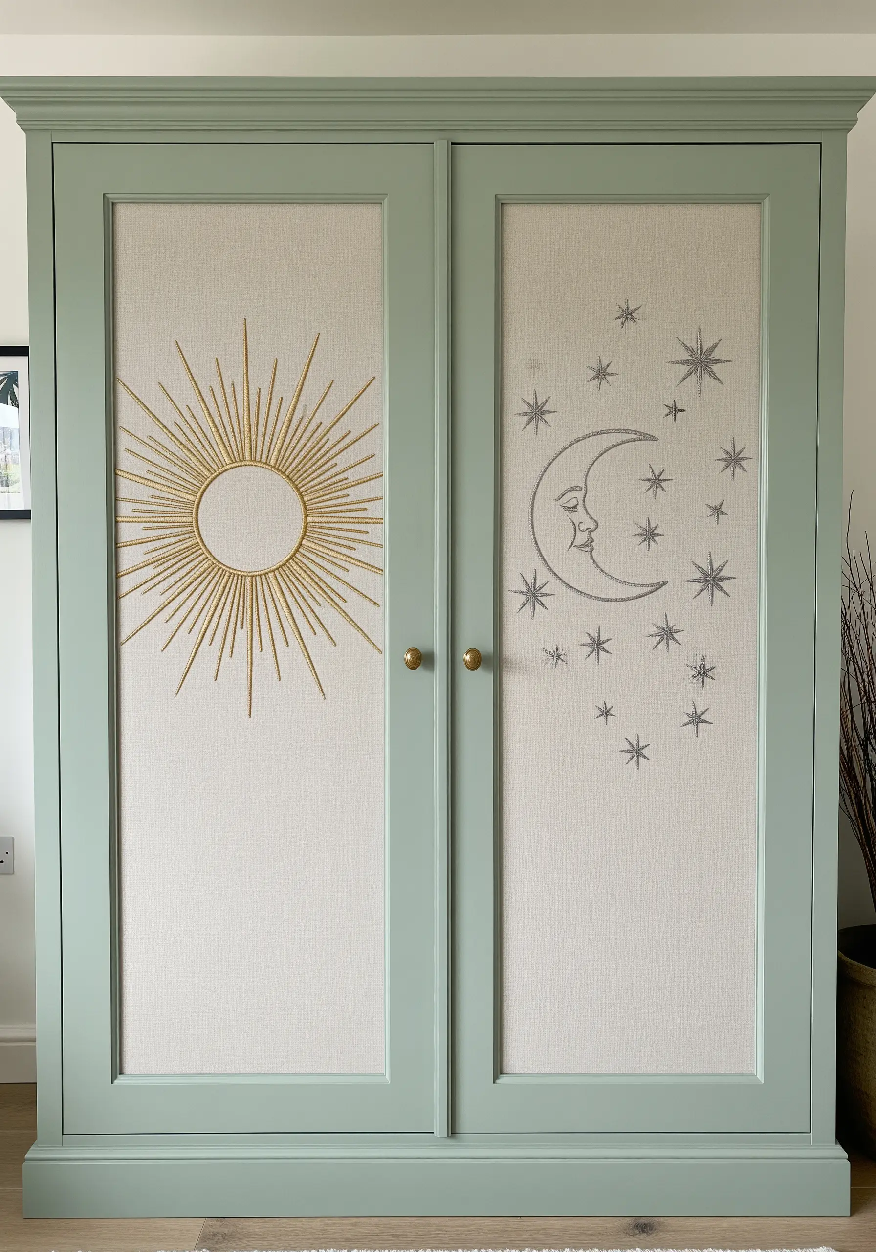 Two wardrobe doors with fabric panels, one embroidered with a gold sun, the other with a silver moon and stars.
