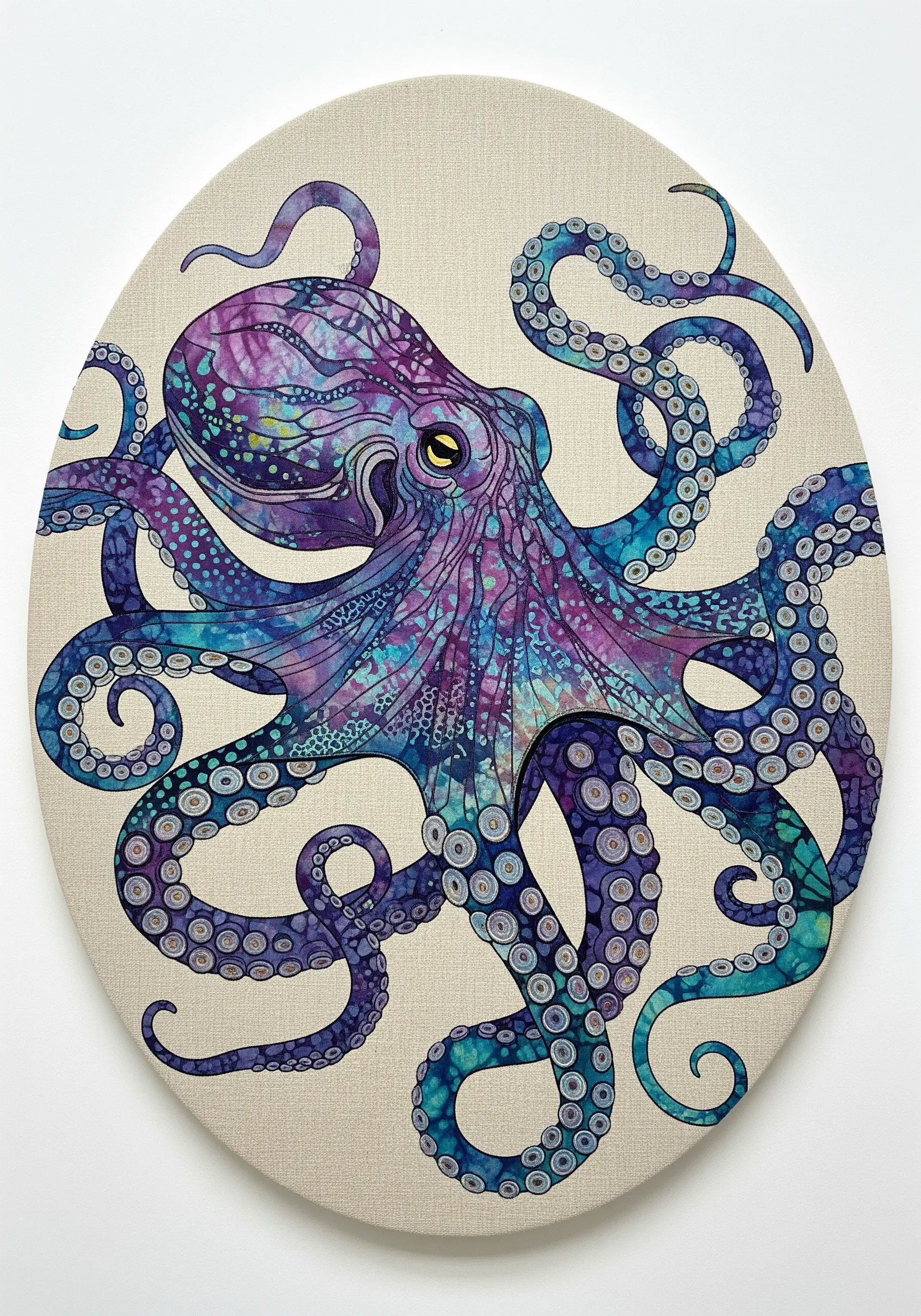 An octopus made from purple and blue batik fabric, with every detail outlined in fine black thread.