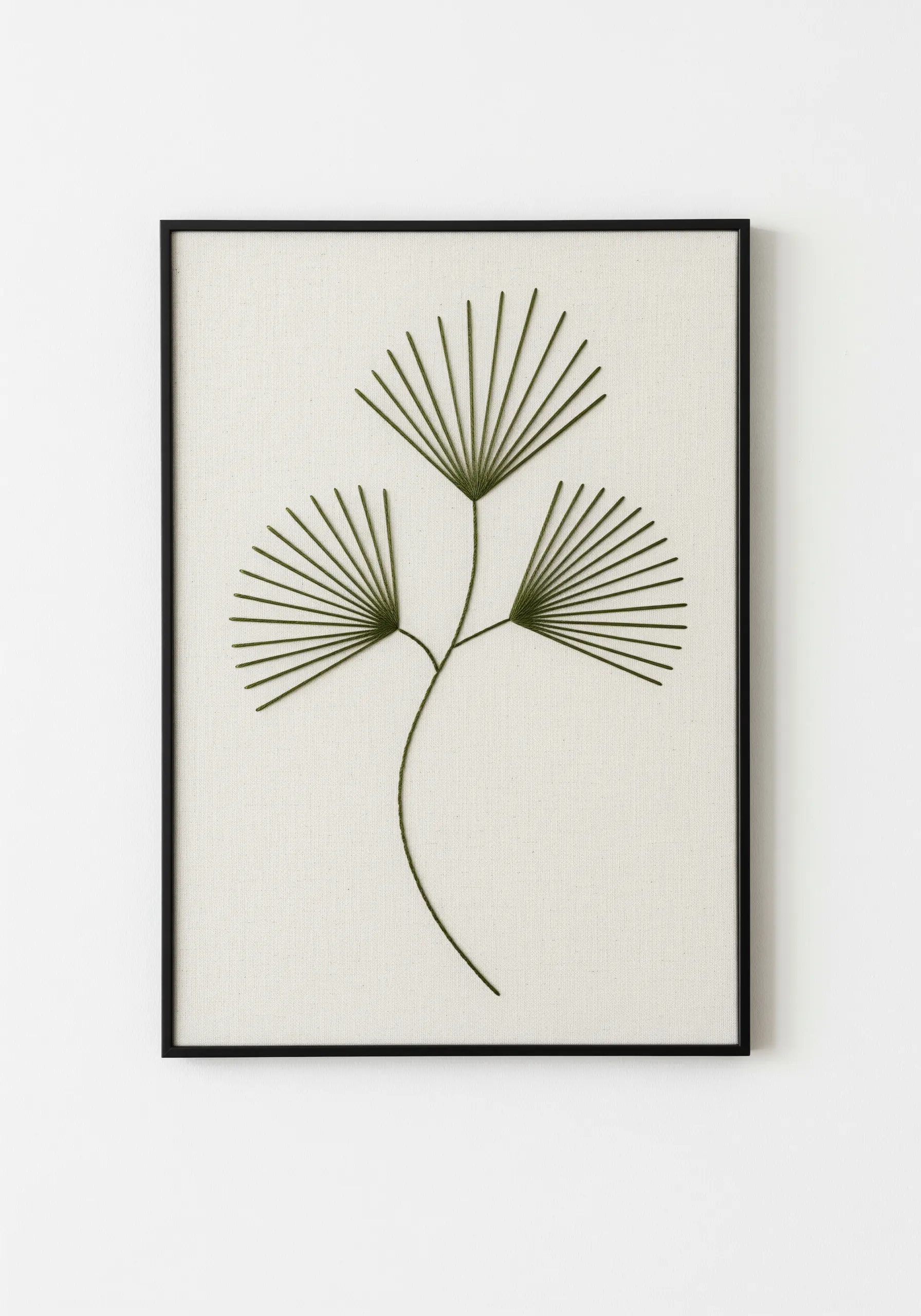 Minimalist botanical embroidery of a fan palm made with radiating green straight stitches.