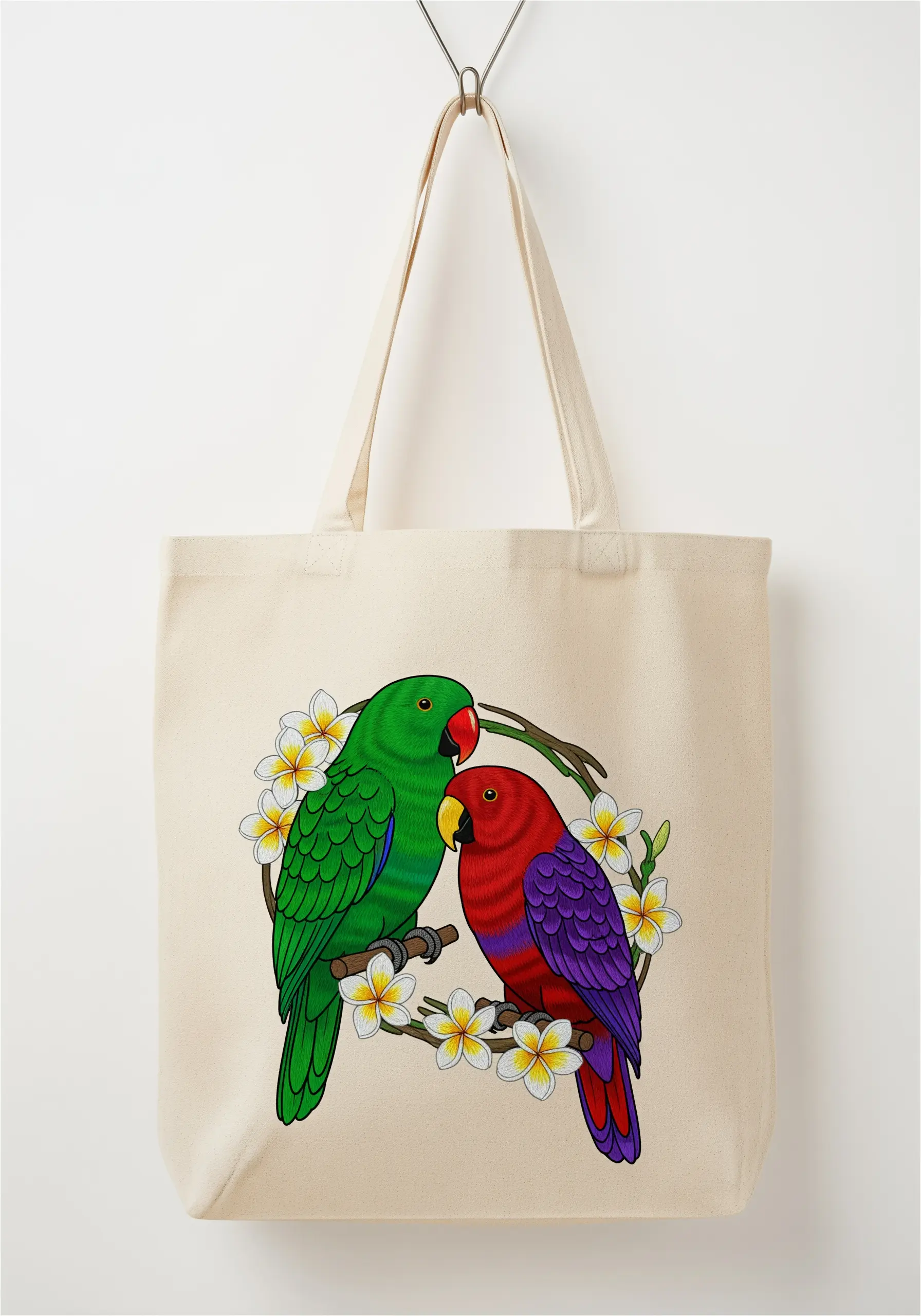 Two graphic-style parrots, one green and one red, on a natural canvas tote bag.