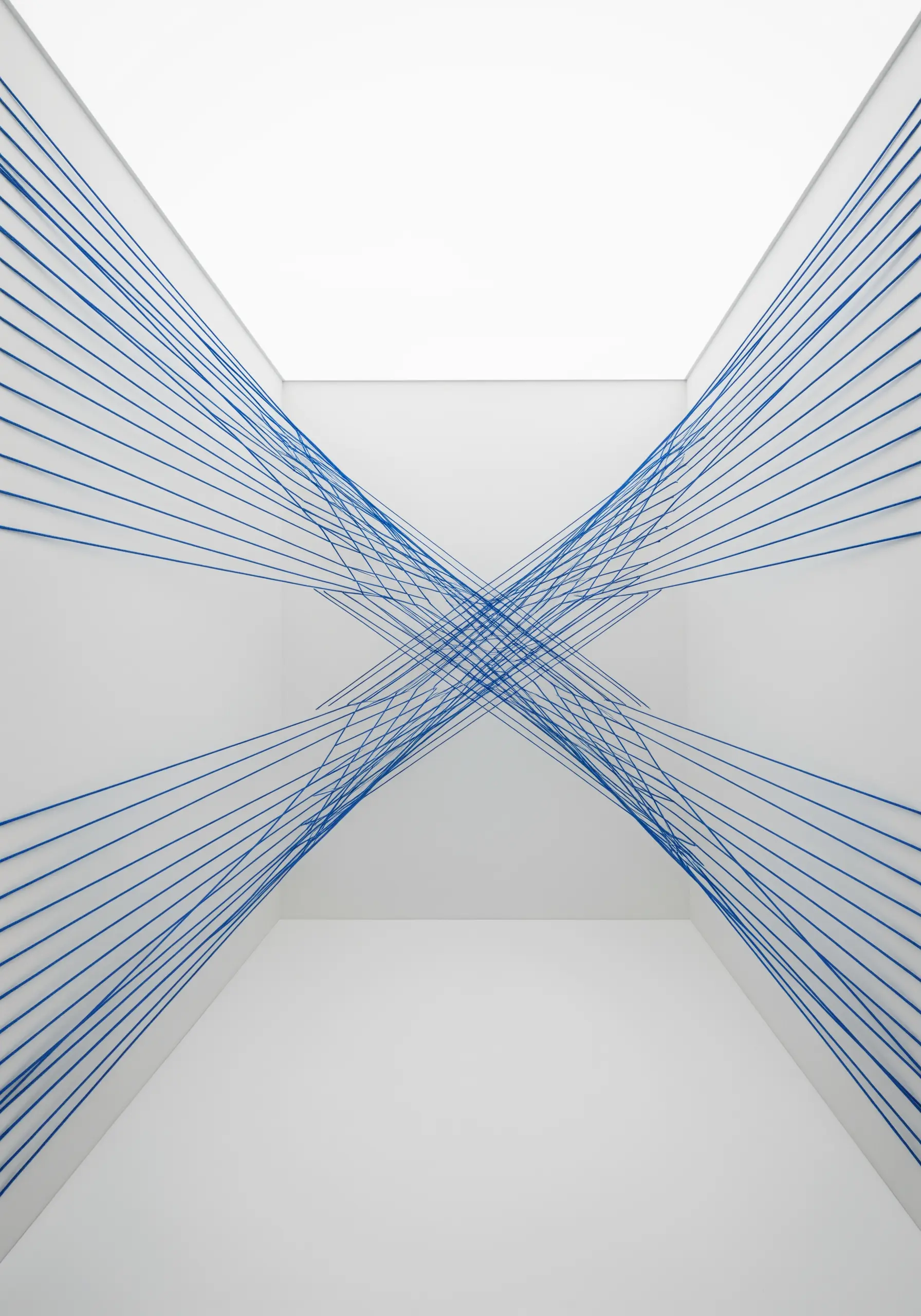 Minimalist installation of taut blue strings crossing a white hallway from wall to wall.