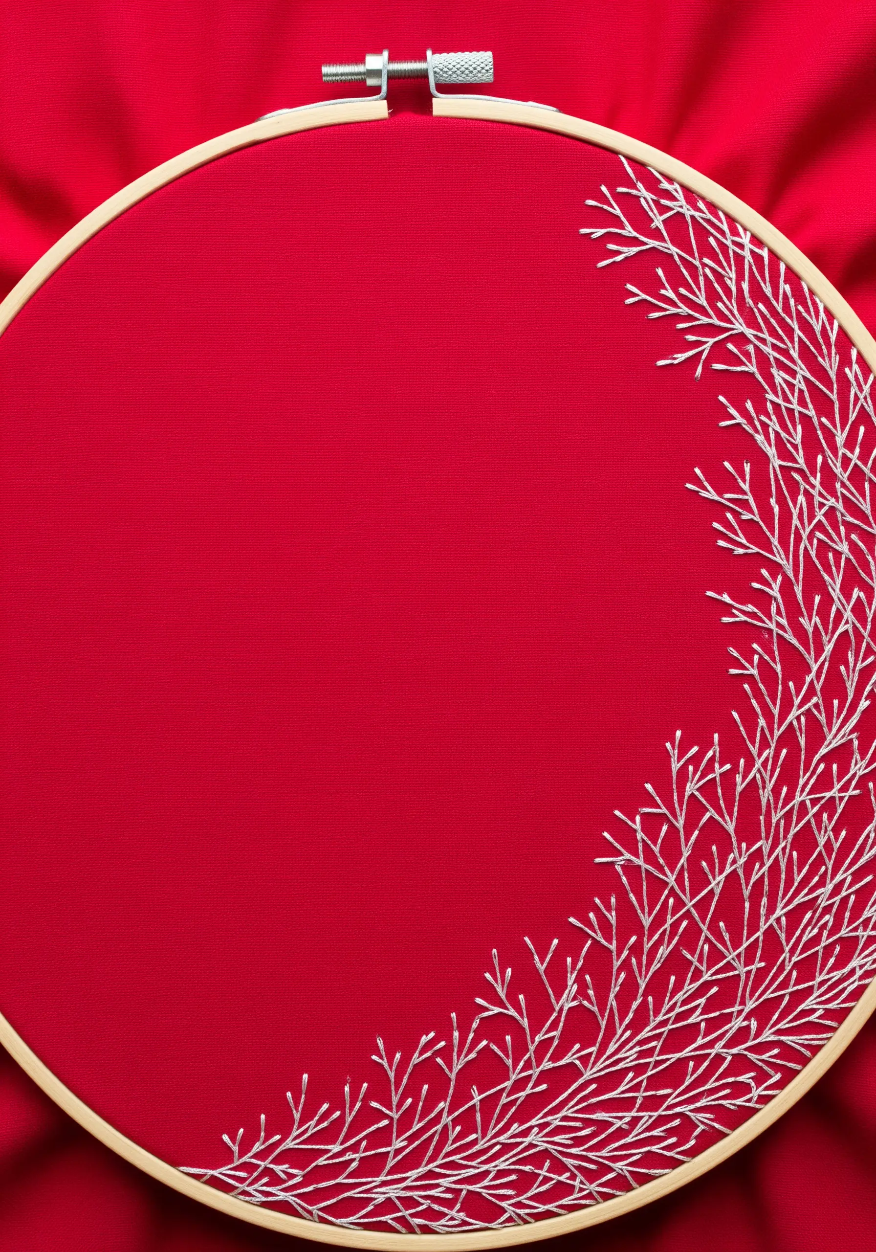 An intricate pattern of white branches growing from the right side of a red hoop.