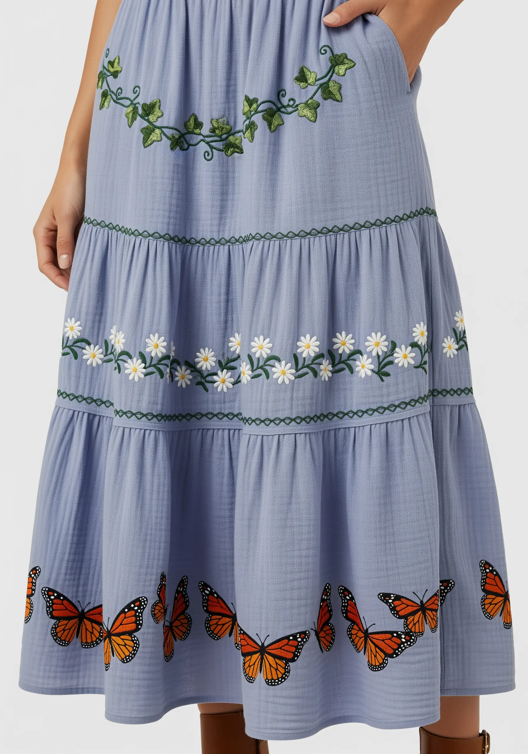 A tiered blue skirt with ivy, daisies, and monarch butterflies on each level.