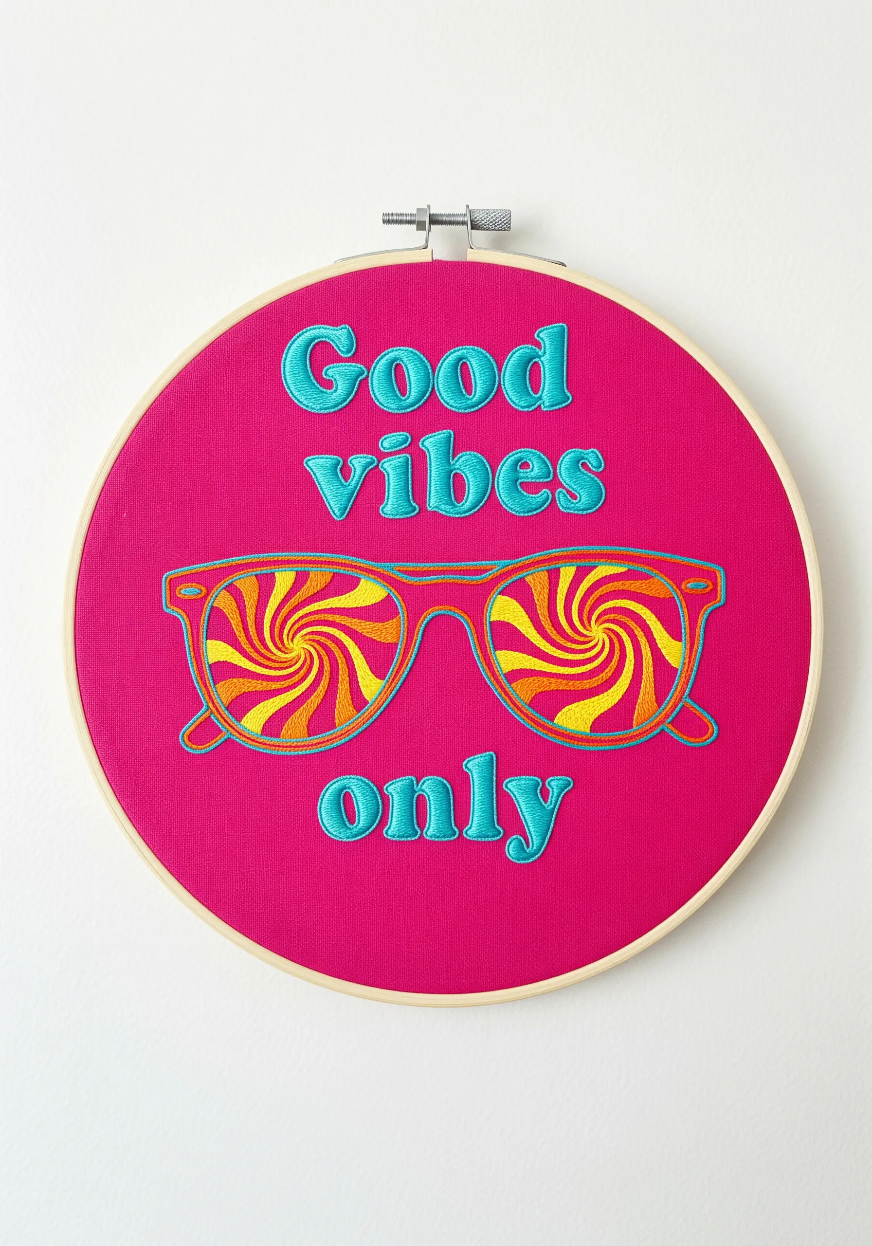 “Good vibes only” quote with sunglasses showing a psychedelic pattern, on bright pink fabric.