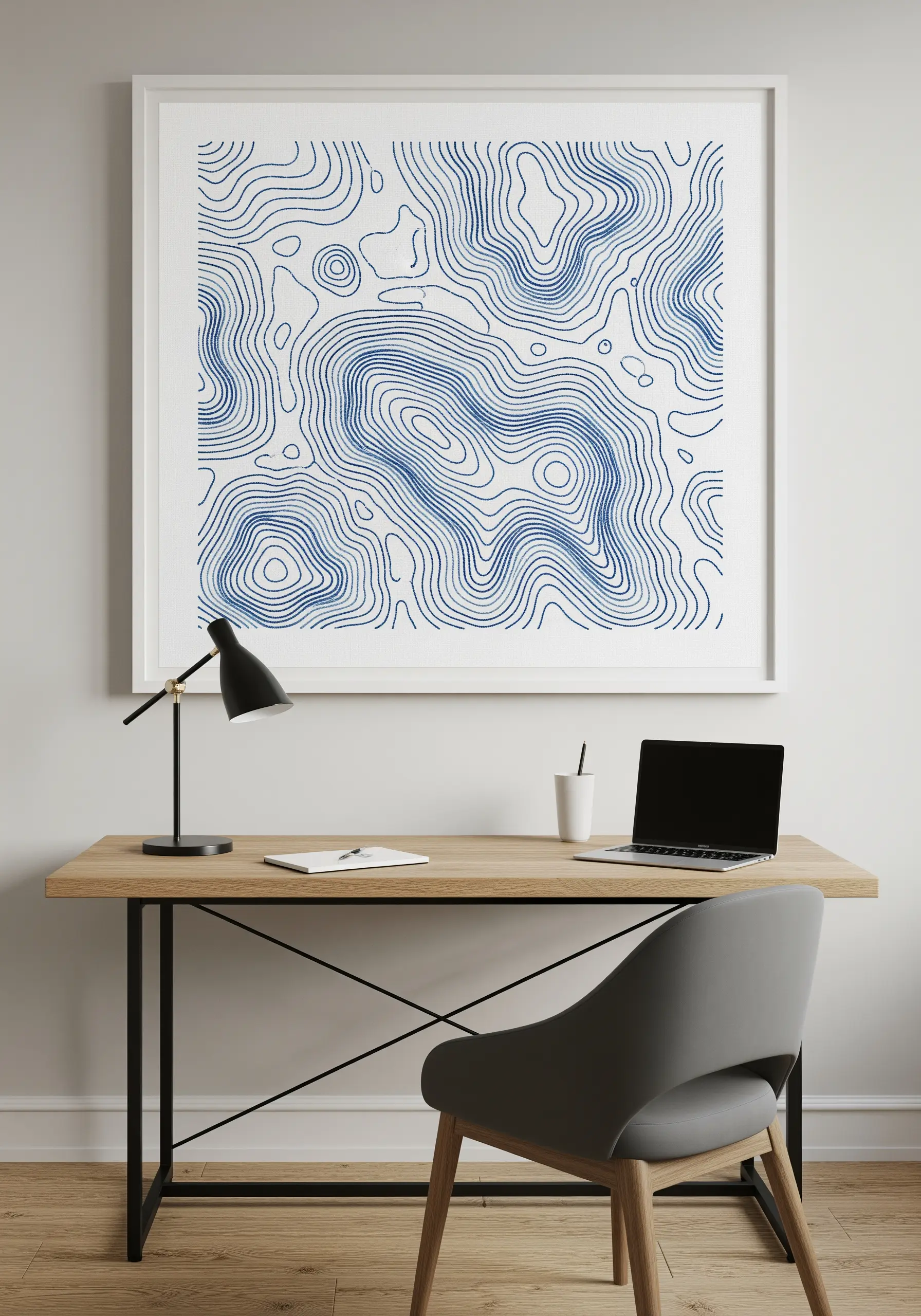 Large framed embroidery of abstract topographic contour lines in blue on a white background.