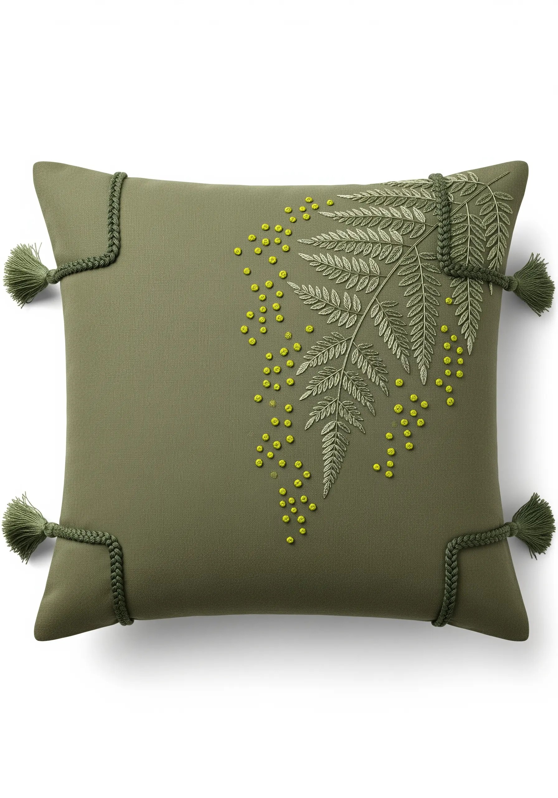 Delicate green fern embroidery on a pillow, accented with yellow French knots.