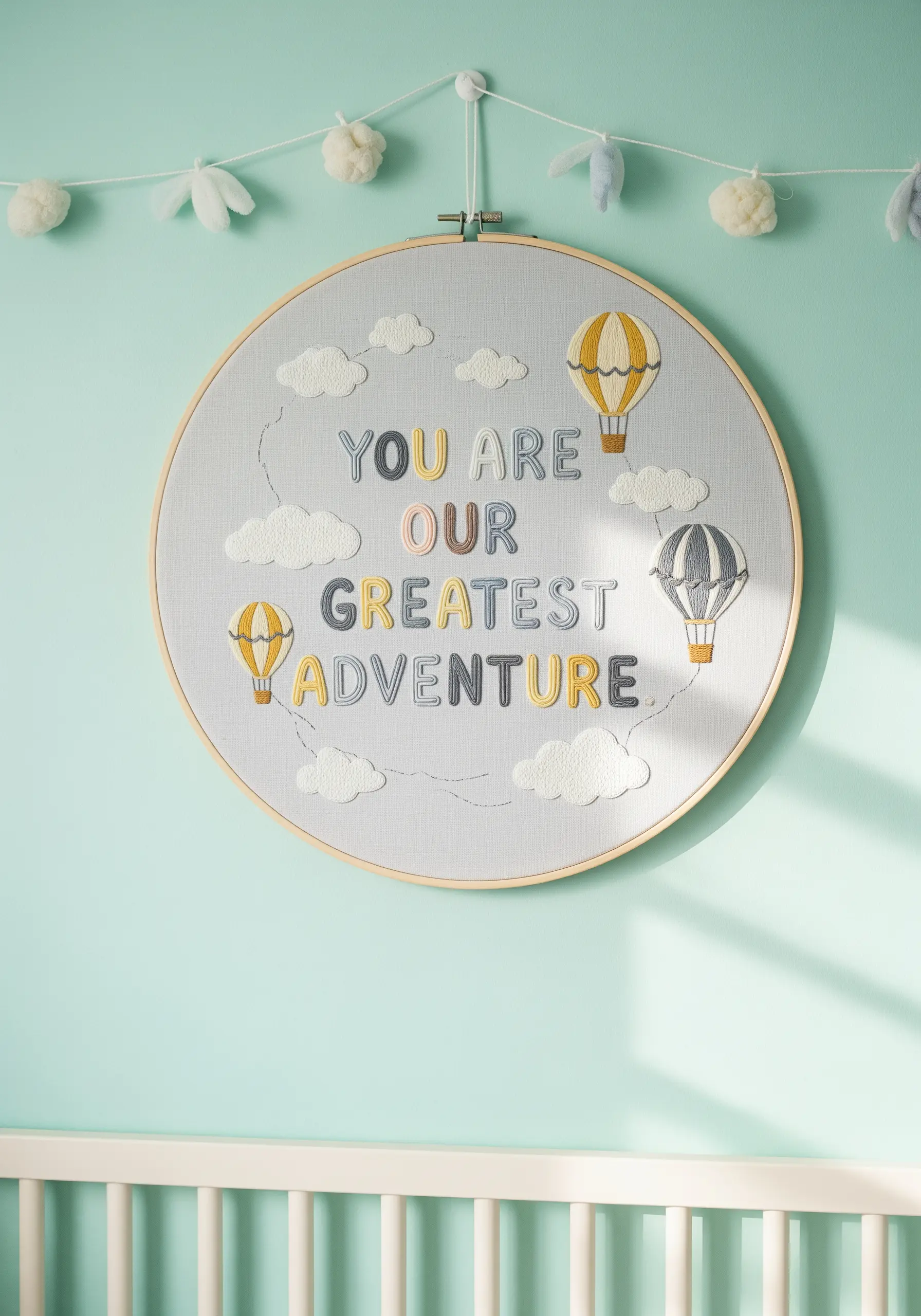 A nursery embroidery hoop with a sweet quote, hot air balloons, and fluffy white clouds.