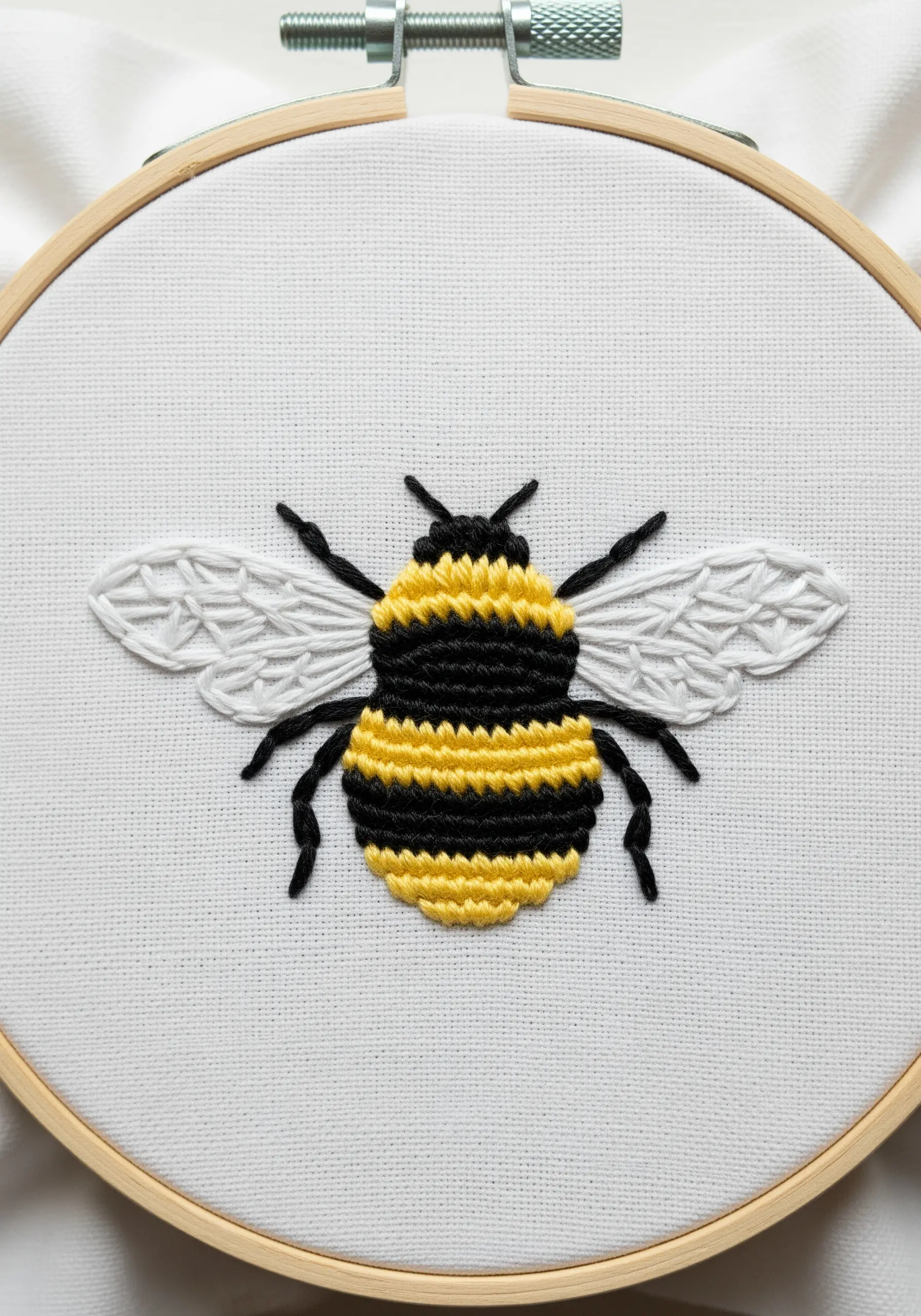 Detailed bumblebee embroidery with geometric wing stitching