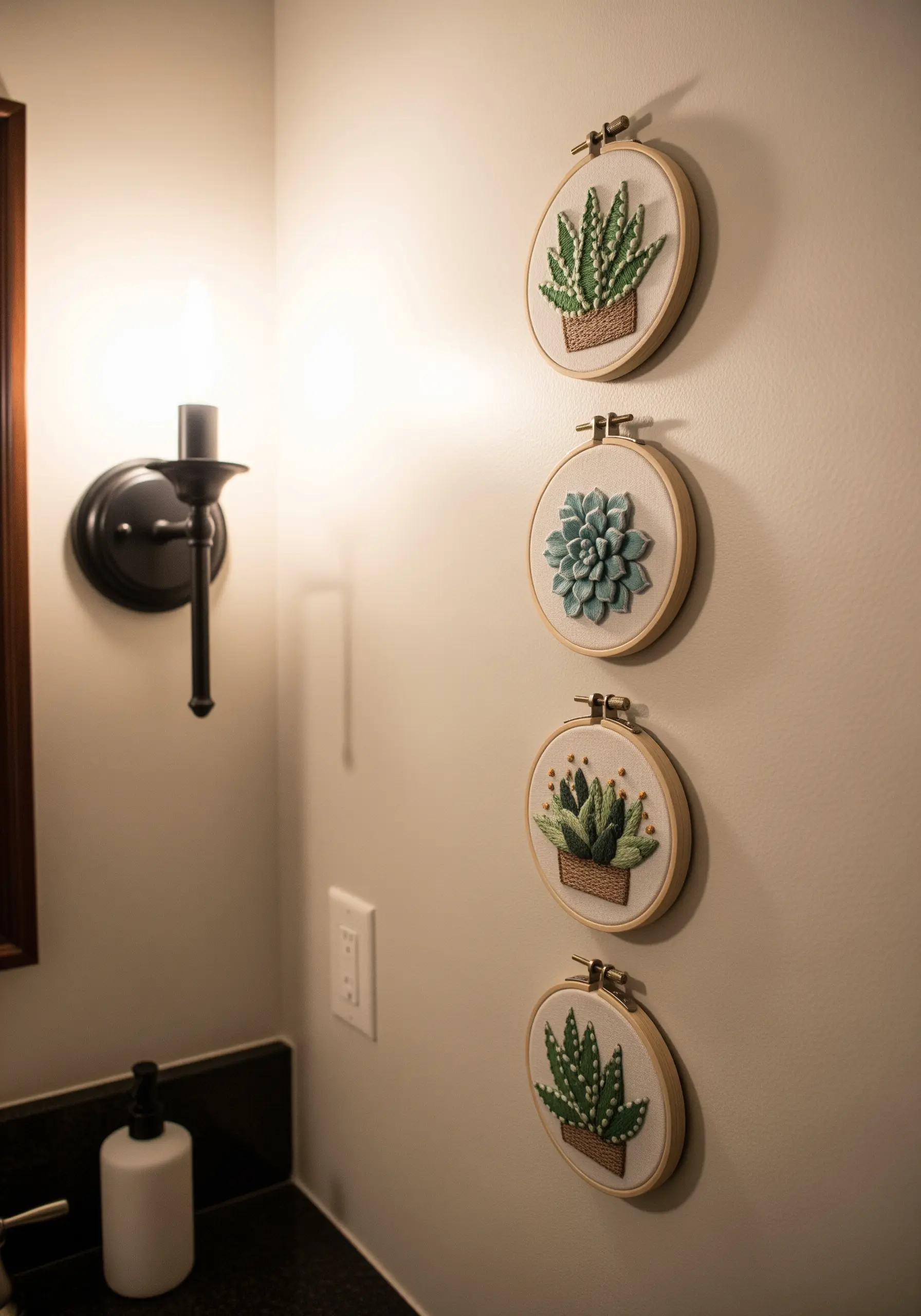 A vertical series of four embroidery hoops, each featuring a different 3D succulent plant.