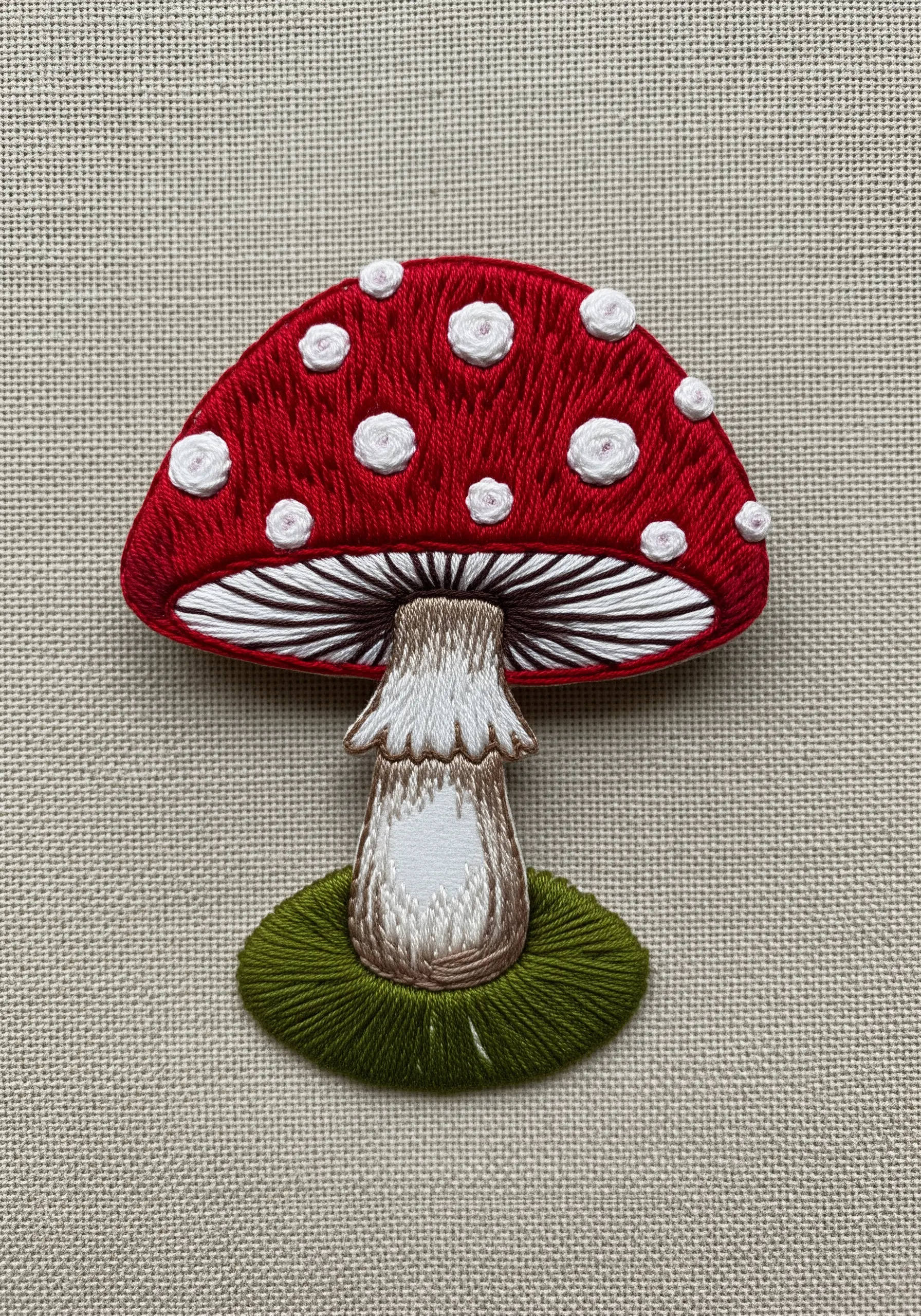 Red mushroom embroidery with white spots and textured stem shading